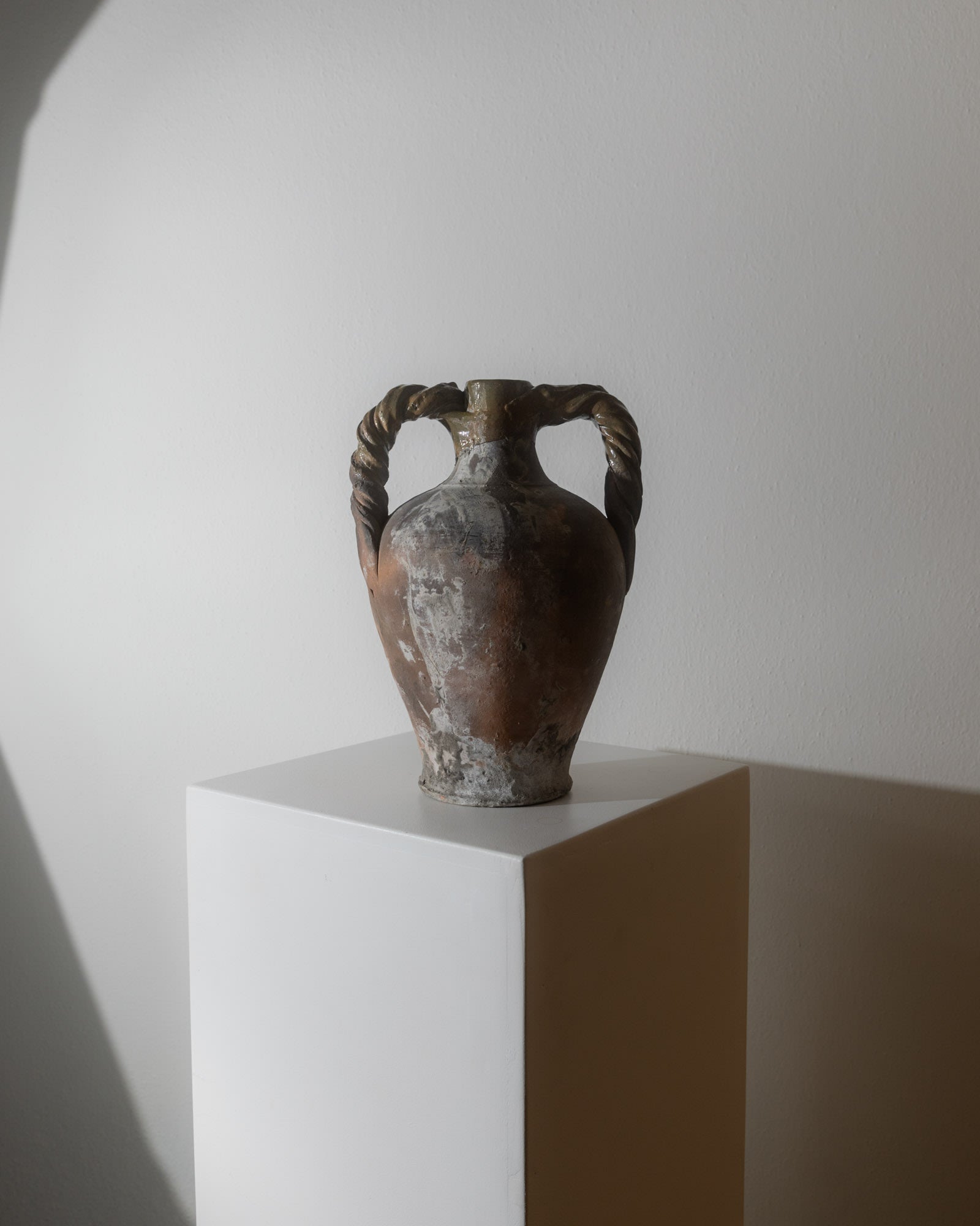 Antique 18th Century Terracotta Amphora — displayed on white pedestal with shadow