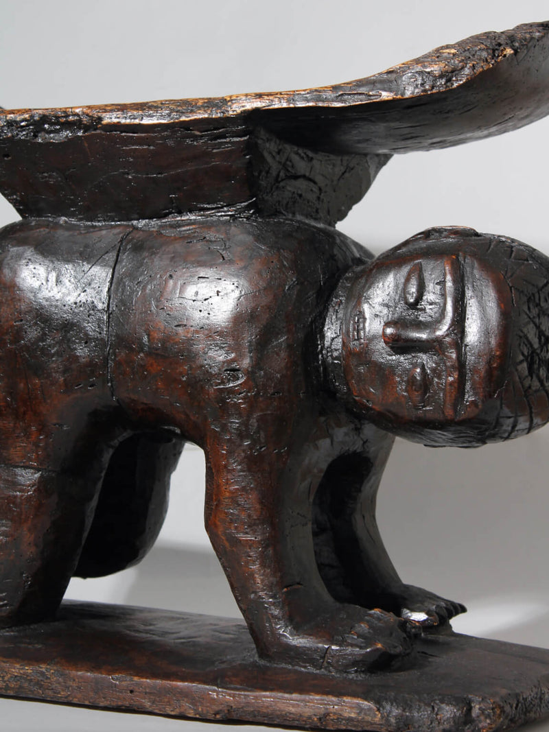Large African Ashanti Figural Stool — close-up of dark wood figure detail