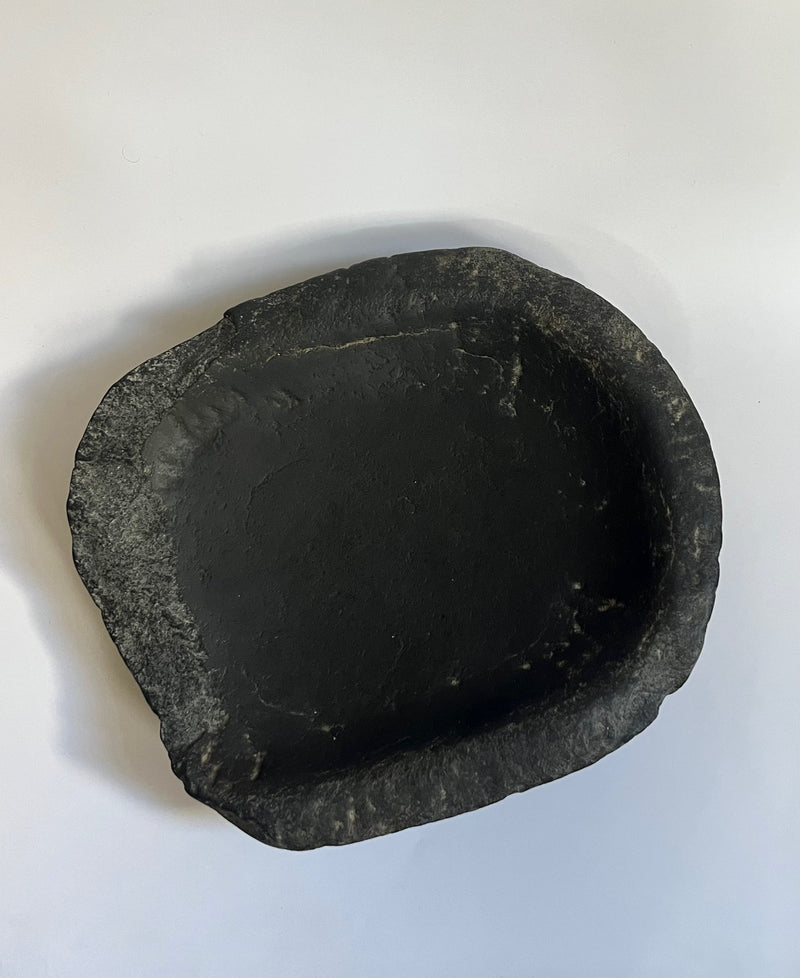 Interior view of antique black stone bowl showing natural texture