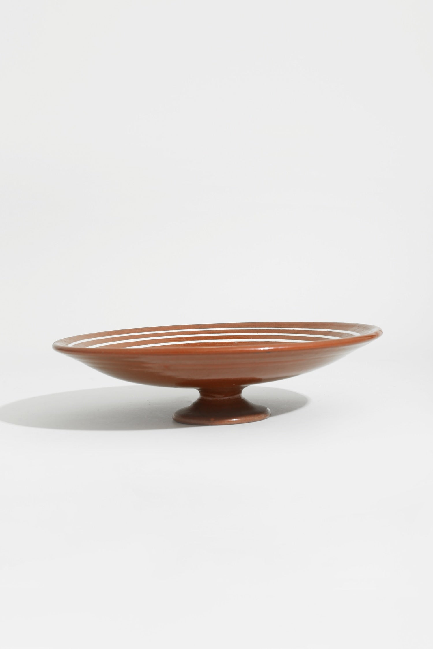Spiral Pedestal Pottery Bowl — side angle showing terracotta finish