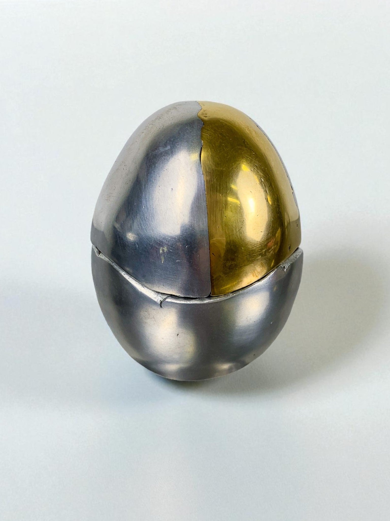 Brutalist Egg shaped lighter-ashtray by Ardisur, Bronze and aluminum, 1970's, Spain — lifestyle setting