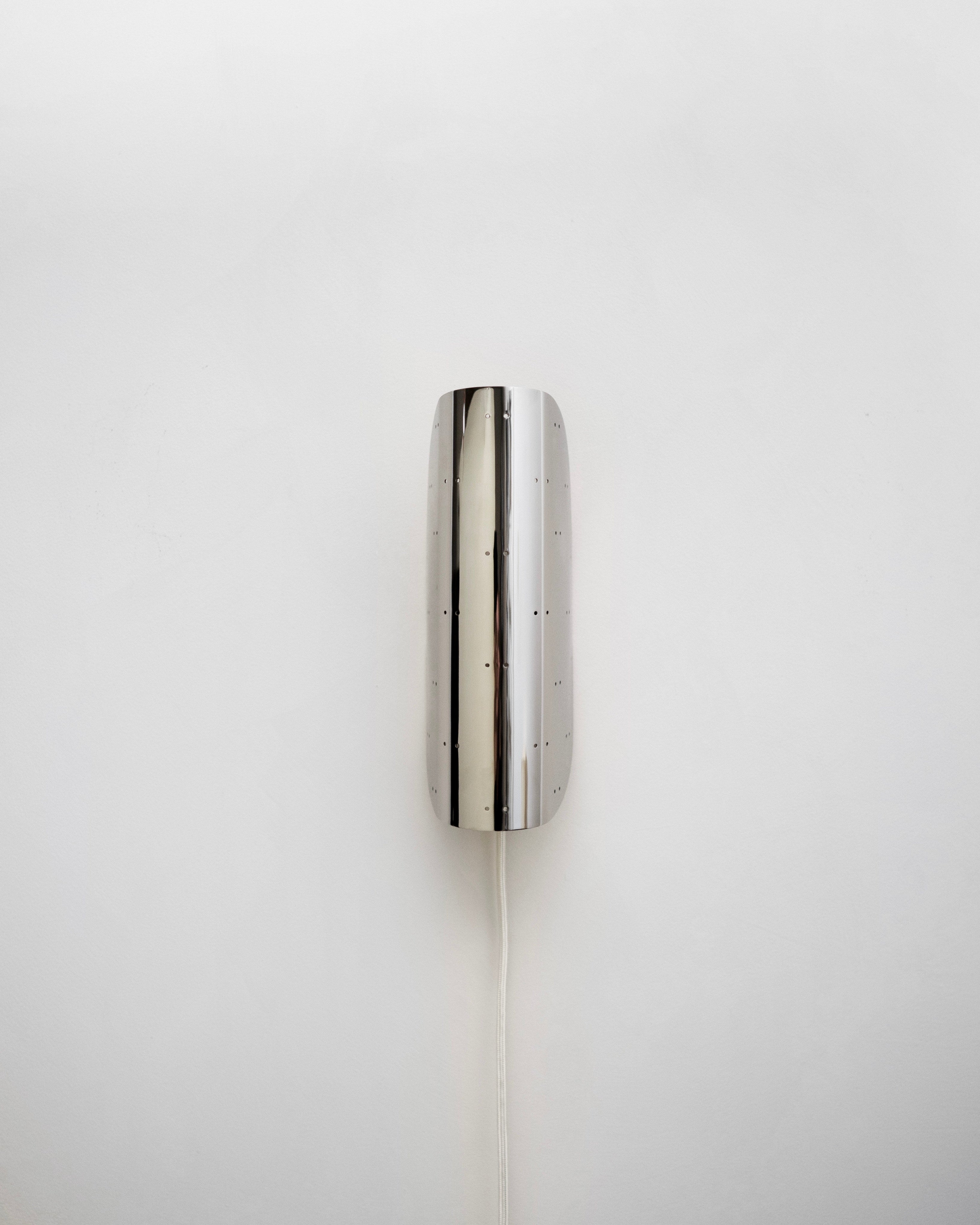 Giselle Wall Lamp - Polished Steel — side angle showing polished surface and cord