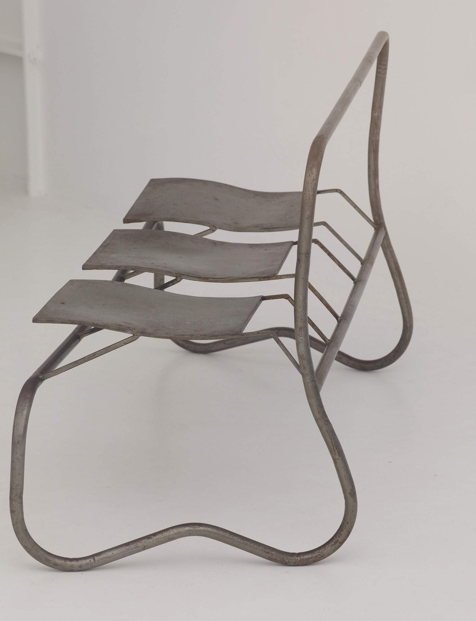 Unique Signed Artist Bench / Settee in Metal — side view of metal frame design
