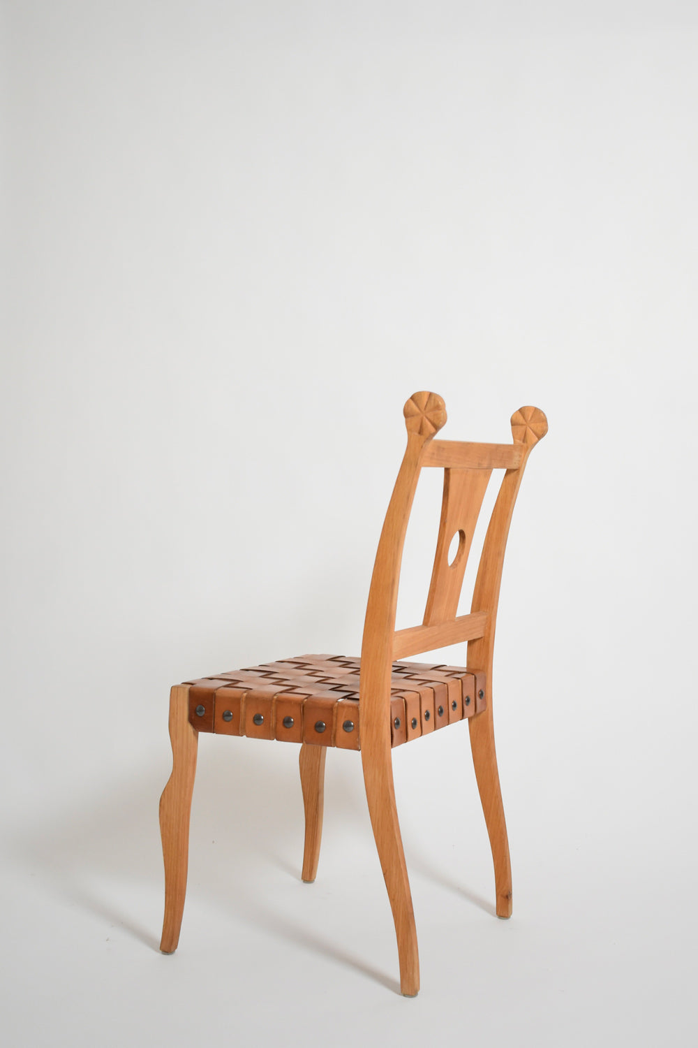 Pair of etruscan oak and leather chairs, 1970s — side angle