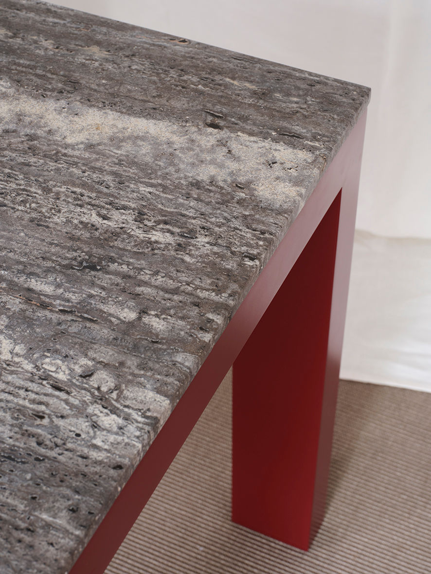 Firme Dining Table — side angle showing gray stone top and red legs