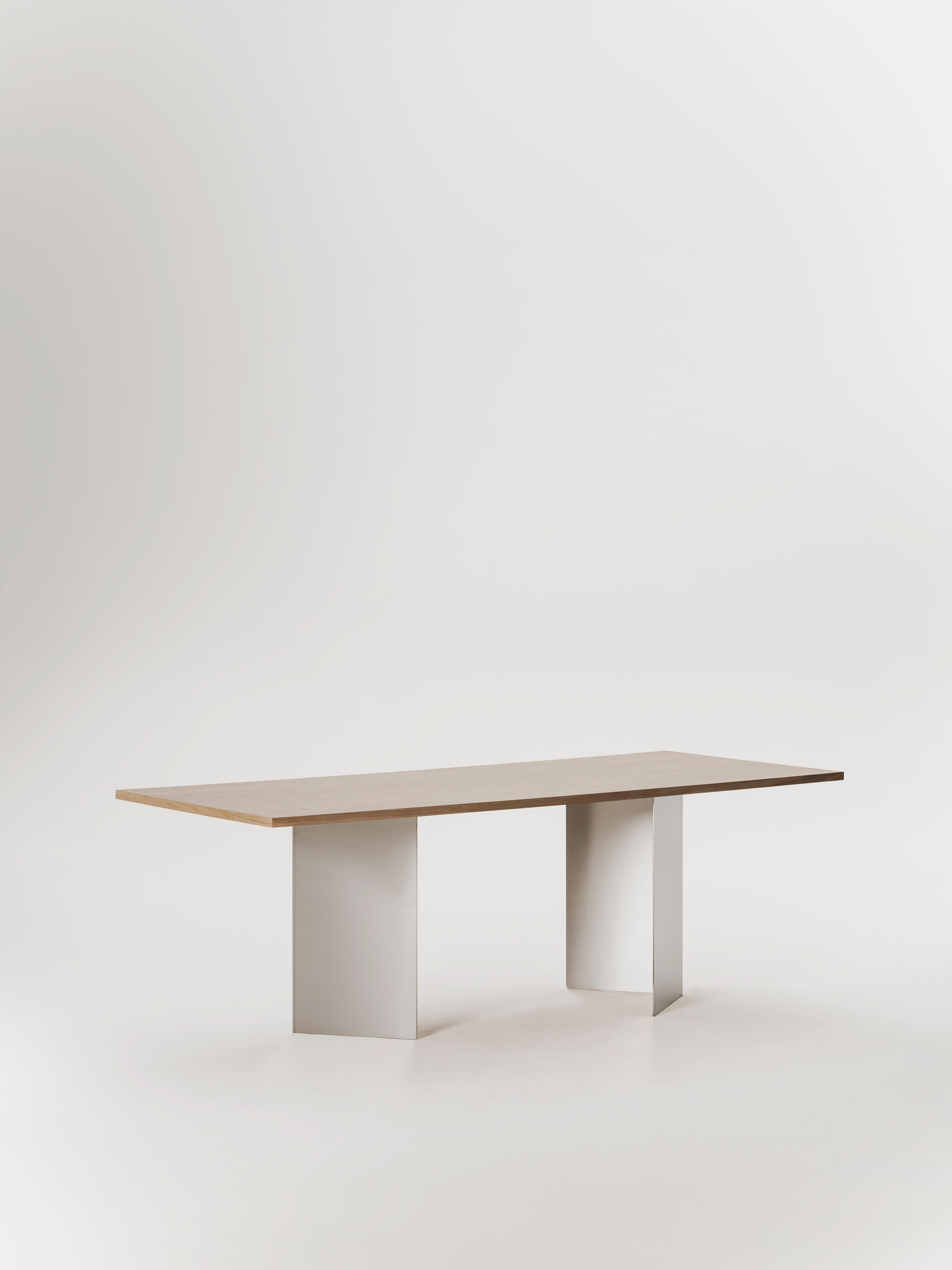 Ander dining table — side angle with light wood top and white legs