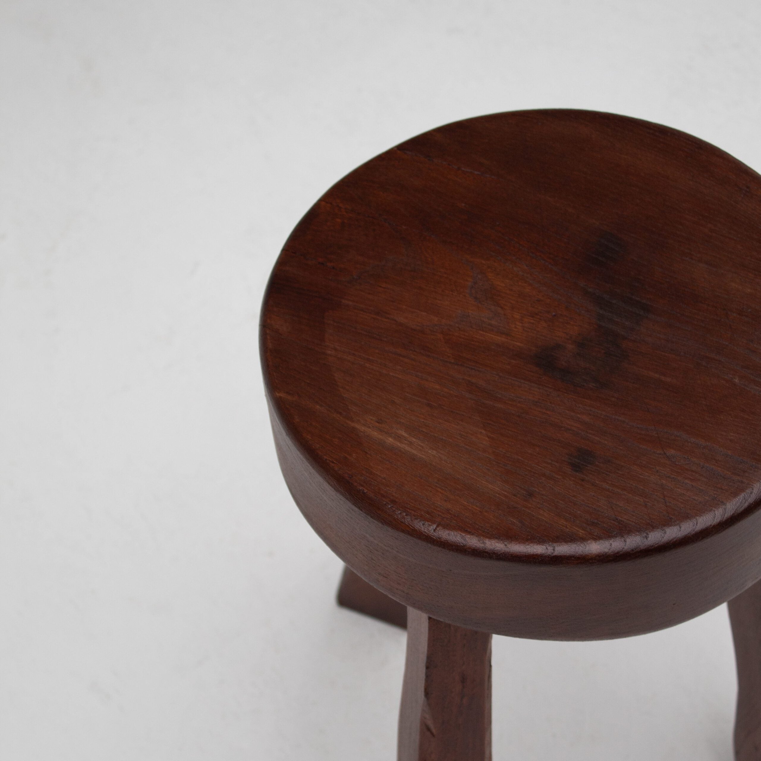 Round Wooden Stool — top view of dark wood seat