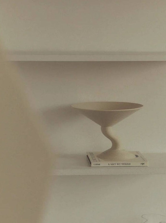 Wavy Fruit Stand — side angle on white shelf with book