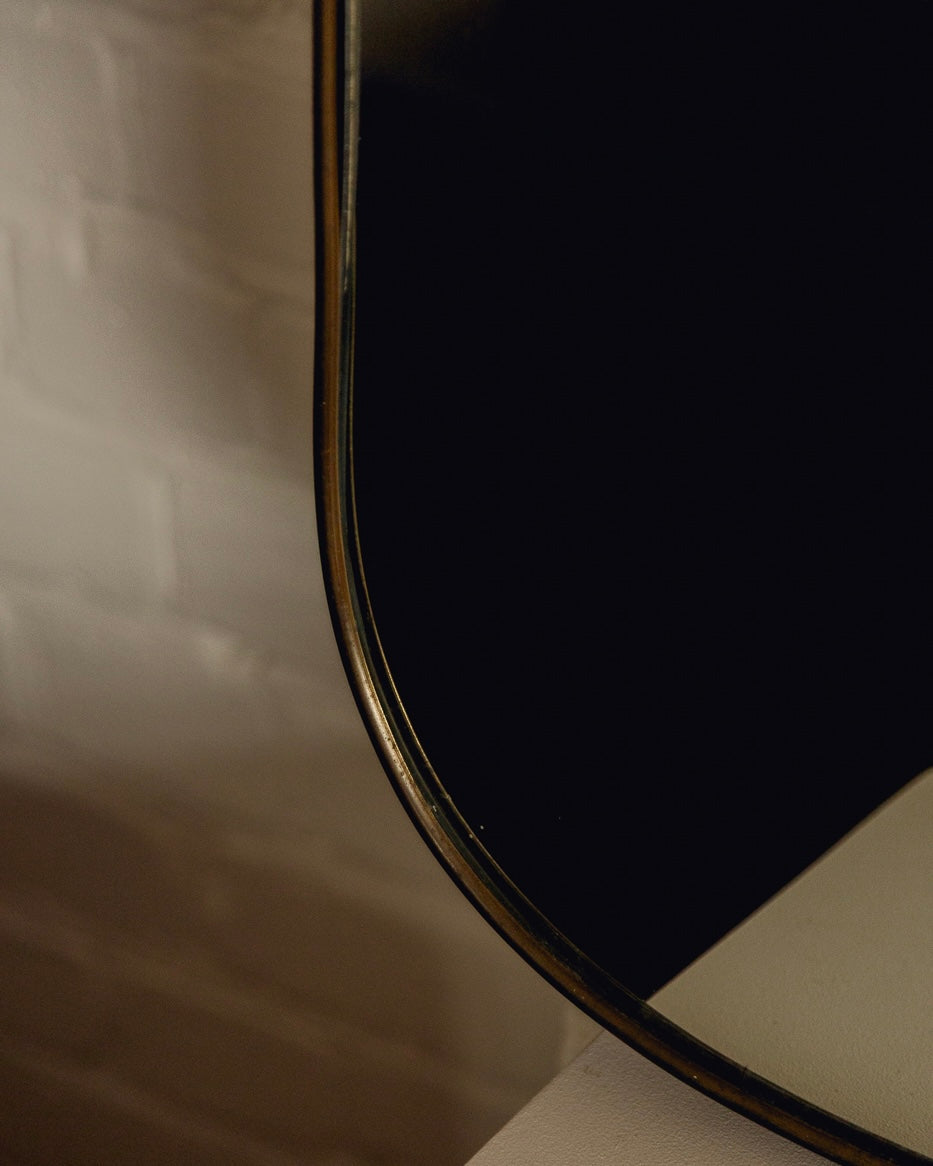 Italian Brass Shield Mirror — lifestyle setting