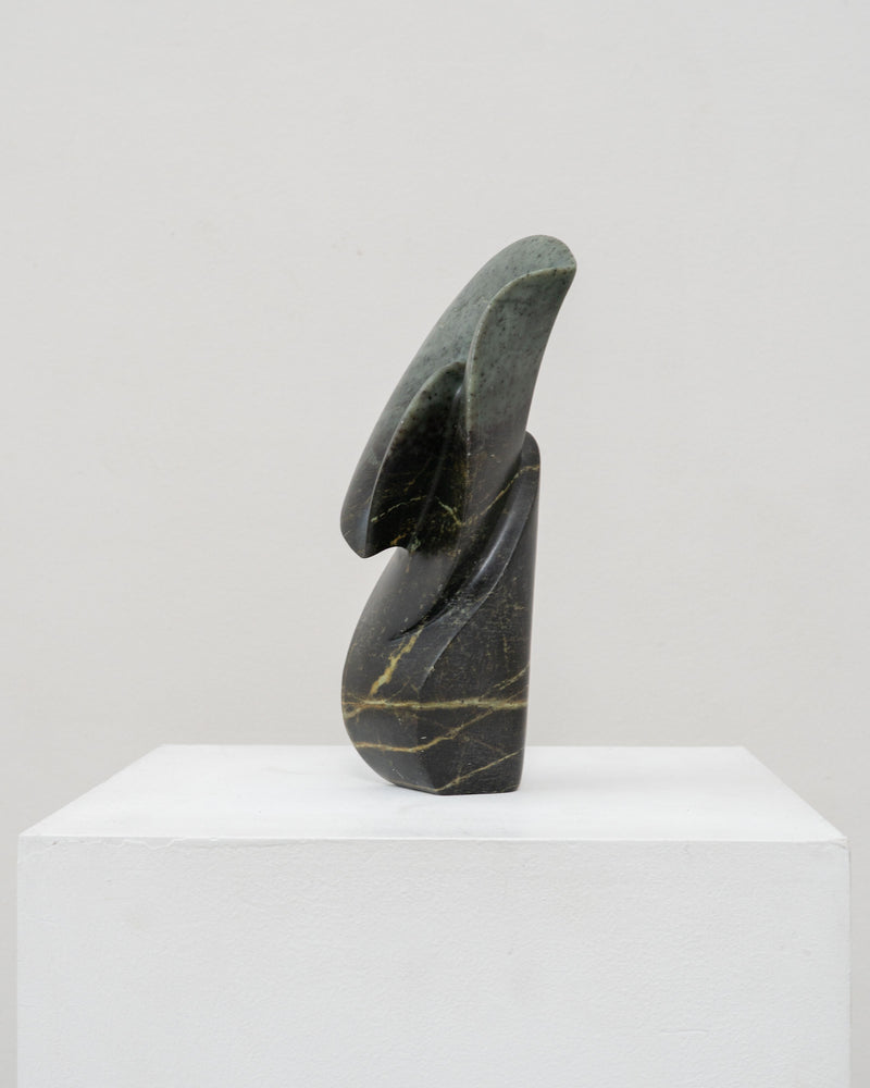Abstract serpentine stone sculpture with curved flowing forms