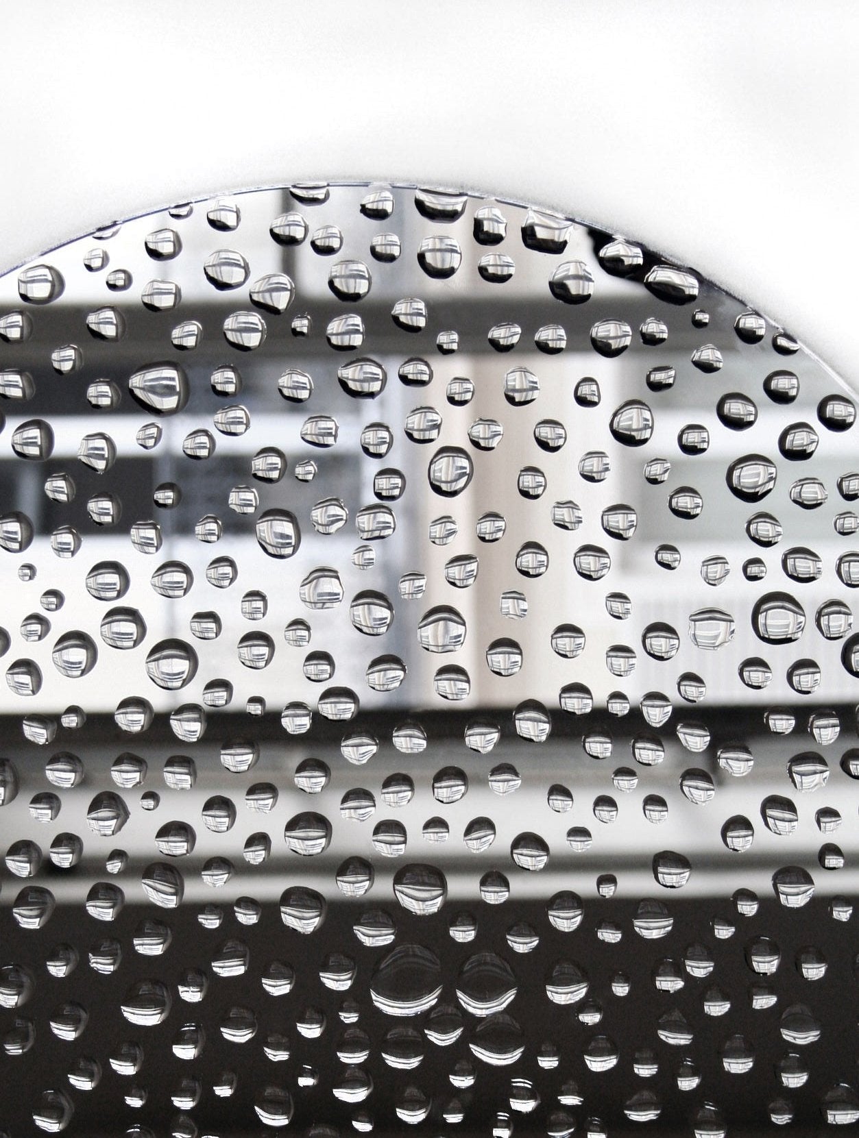 Mirror 11H20 — close-up of reflective surface with water droplets