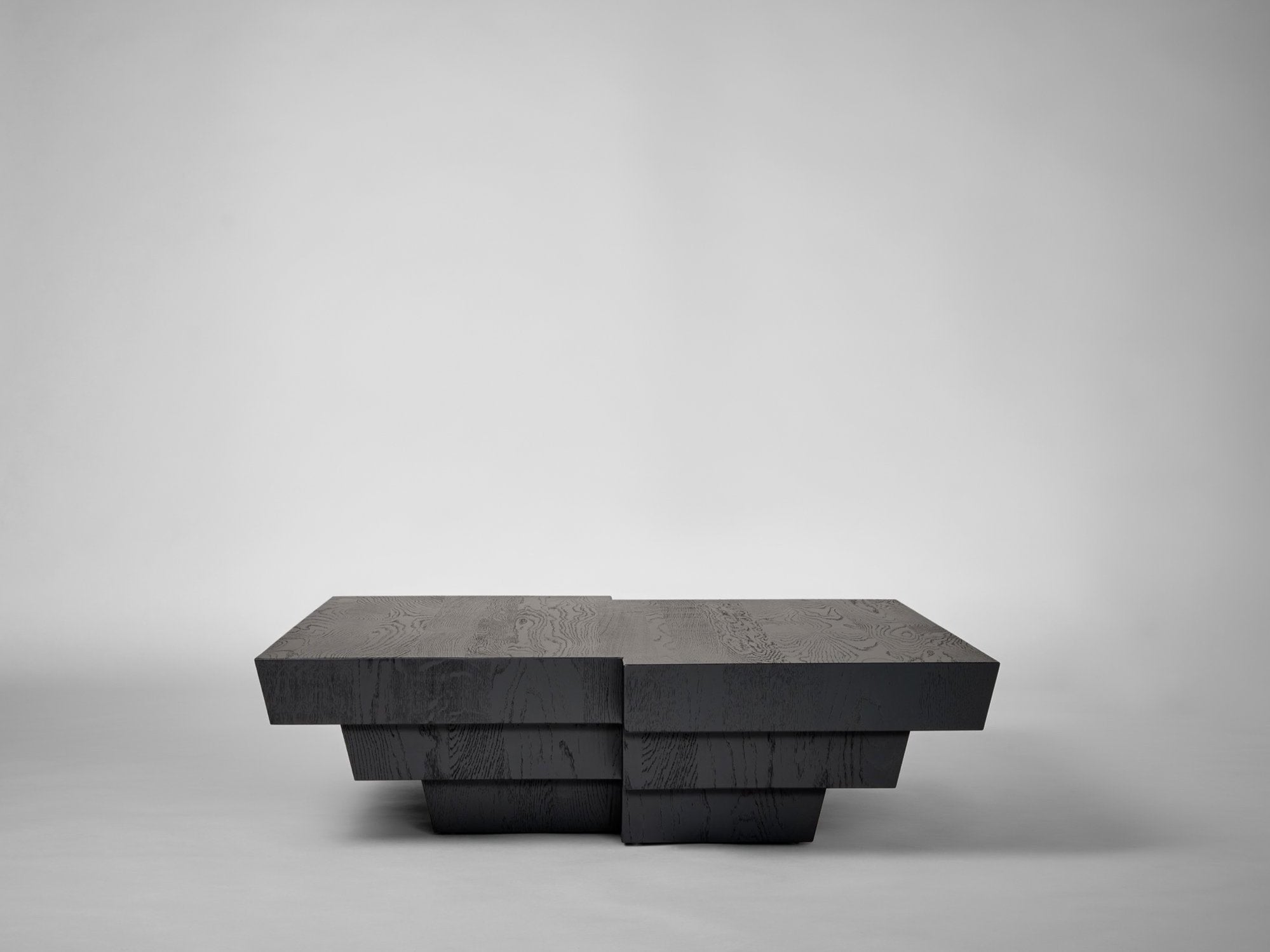 Taes Coffee Table — side angle showing dark wood finish and geometric design