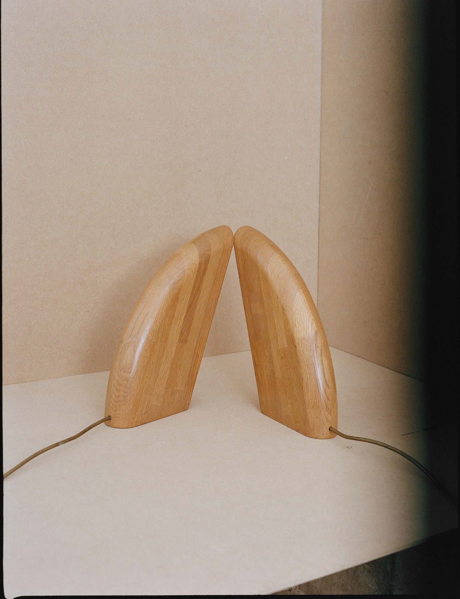 Set of 2 Vintage French Artisanal Table Lamps in Solid Oak Wood C. 1980 — angled view highlighting curved oak bases