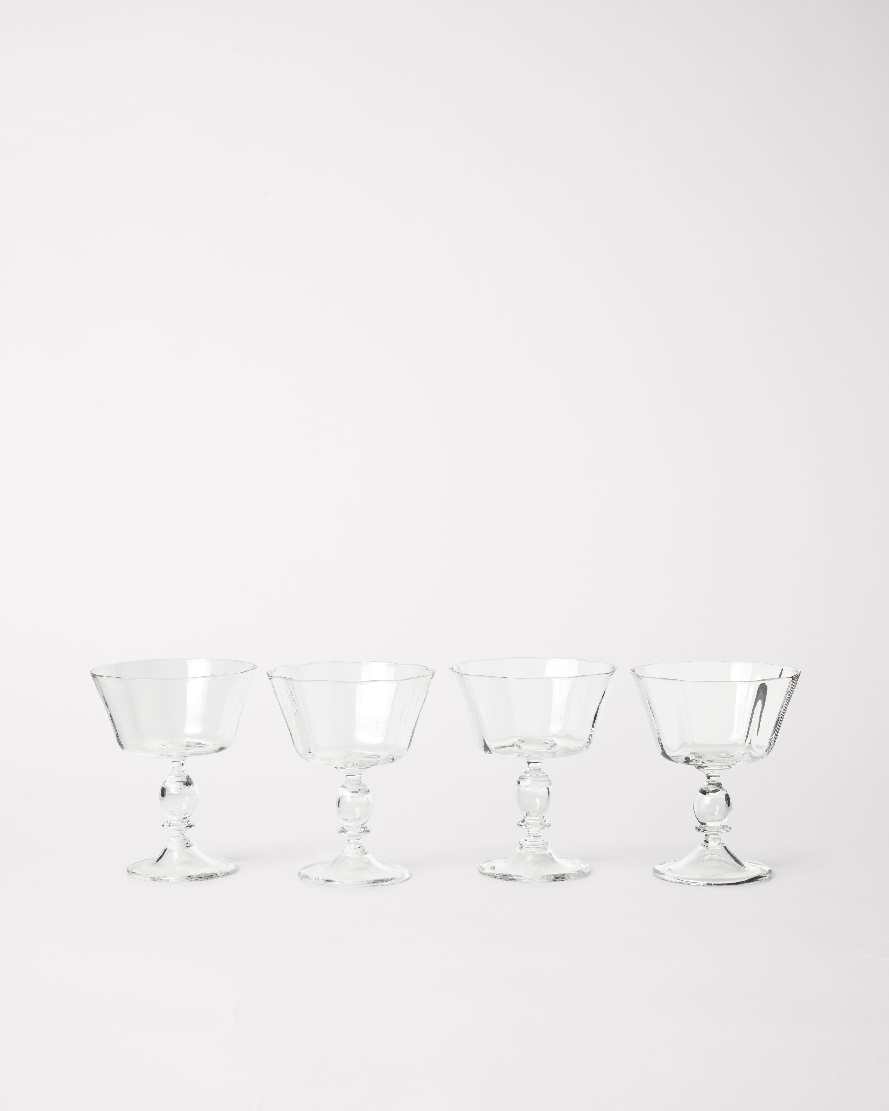 Alban Champagne Glass - Set of Four — arranged in a row on white background