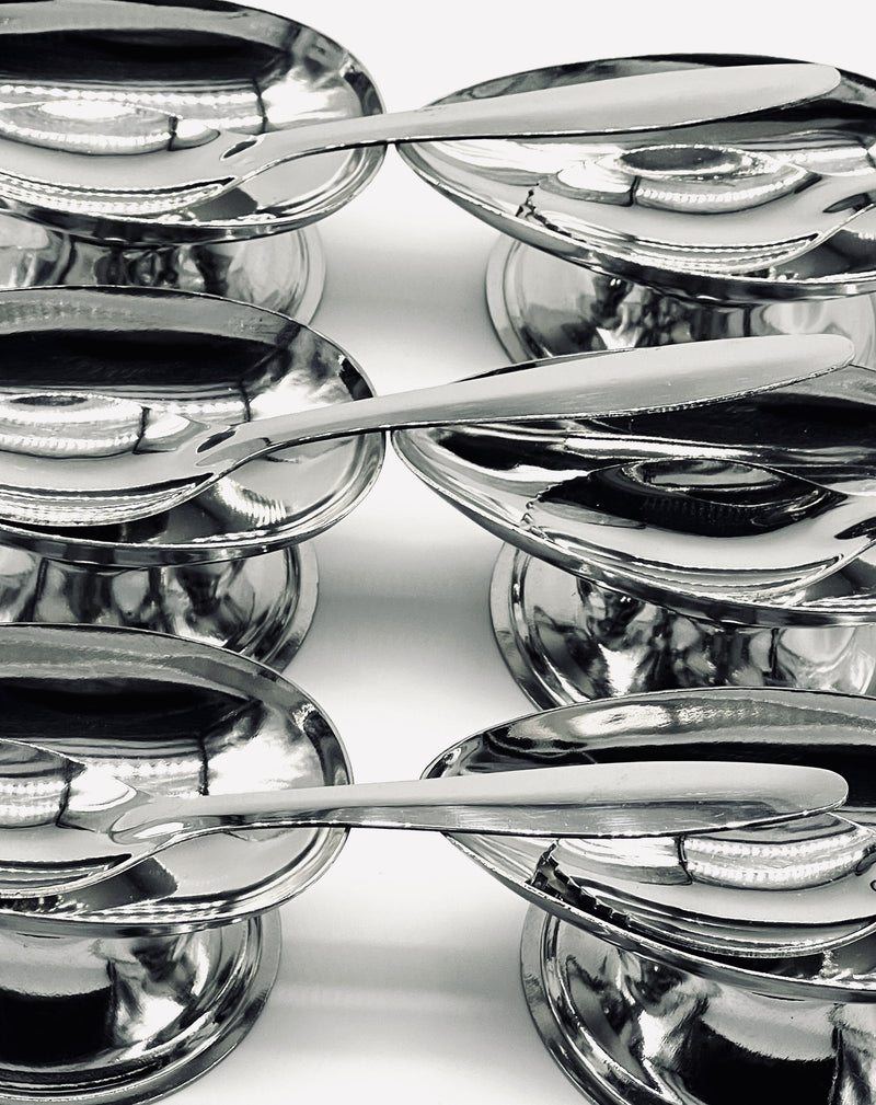 Close-up detail of stainless steel avocado coupes showing reflective curved bowls
