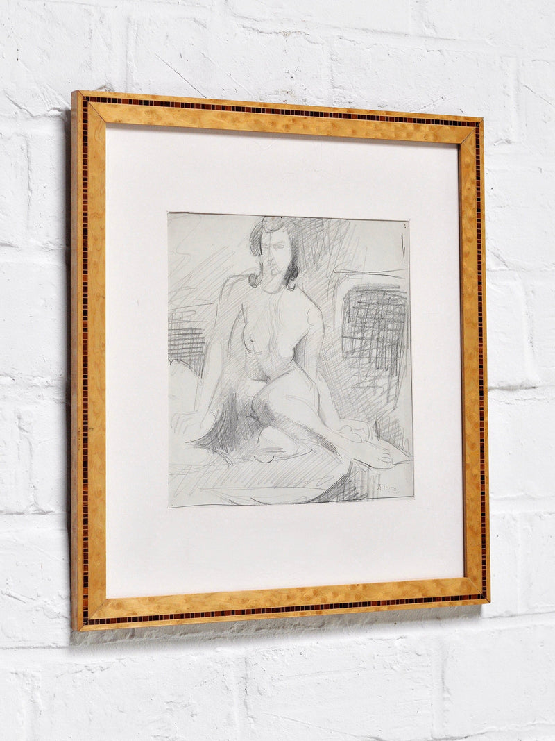 André Lhote (1885–1962) Drawing in Pencil by Introverso: Nude woman seated, visible sketch lines, wide white mat, light wood frame, displayed on a white brick wall.