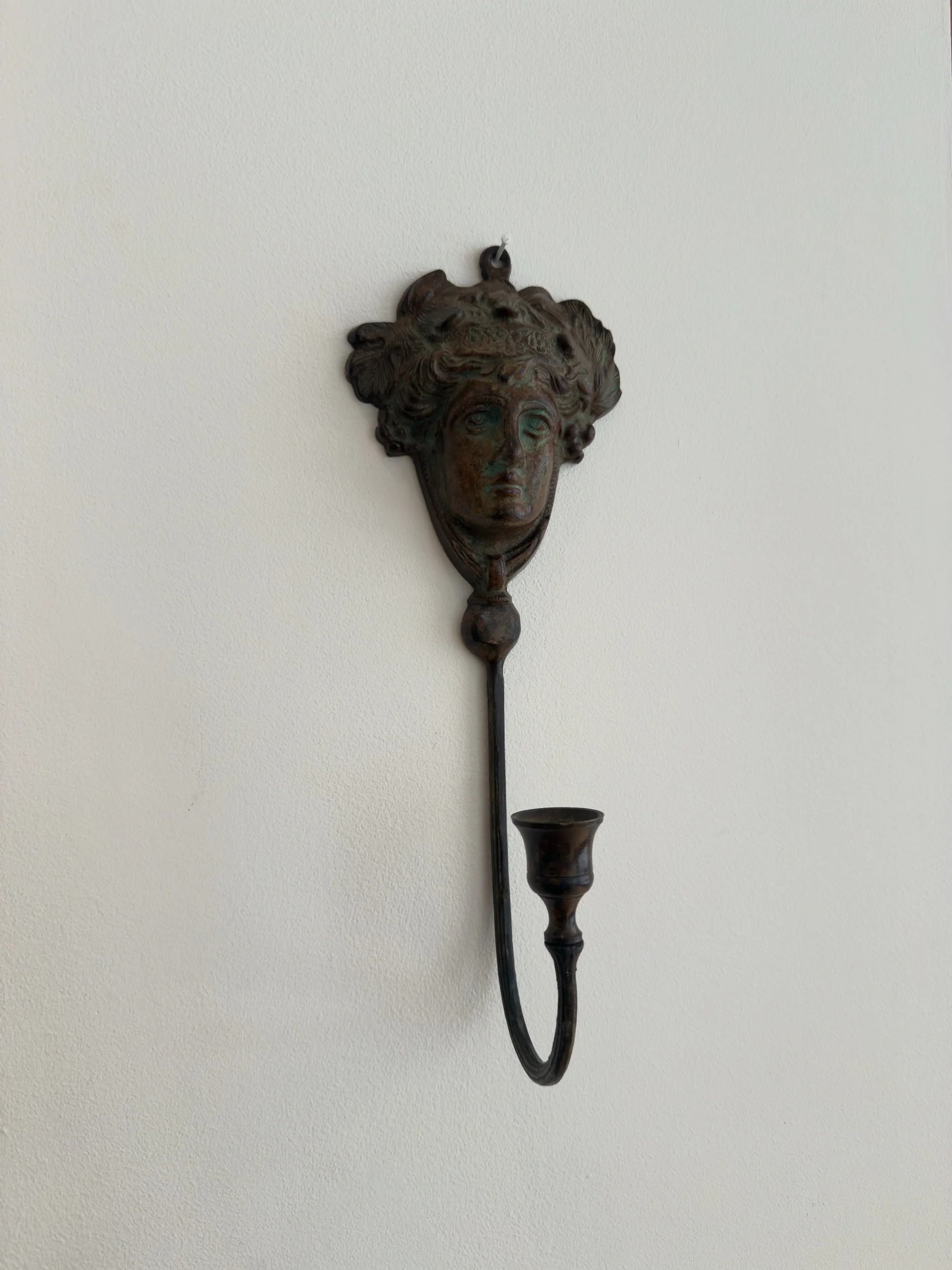 Neoclassical Bronze Candle Sconce — wall-mounted in minimalist setting