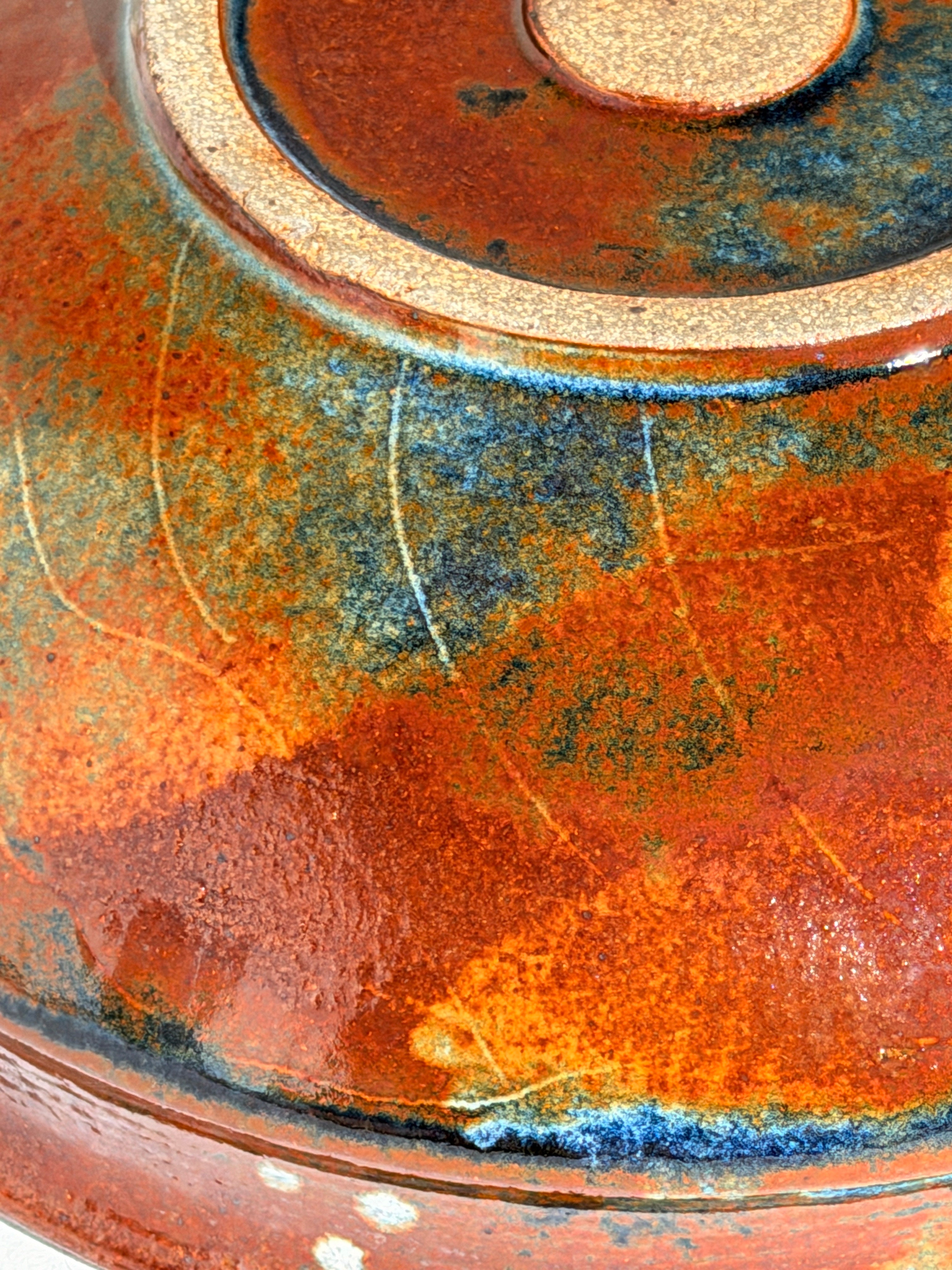 Ceramic dish by Elisabeth Wallet, circa 1960–1970 — close-up of textured orange glaze