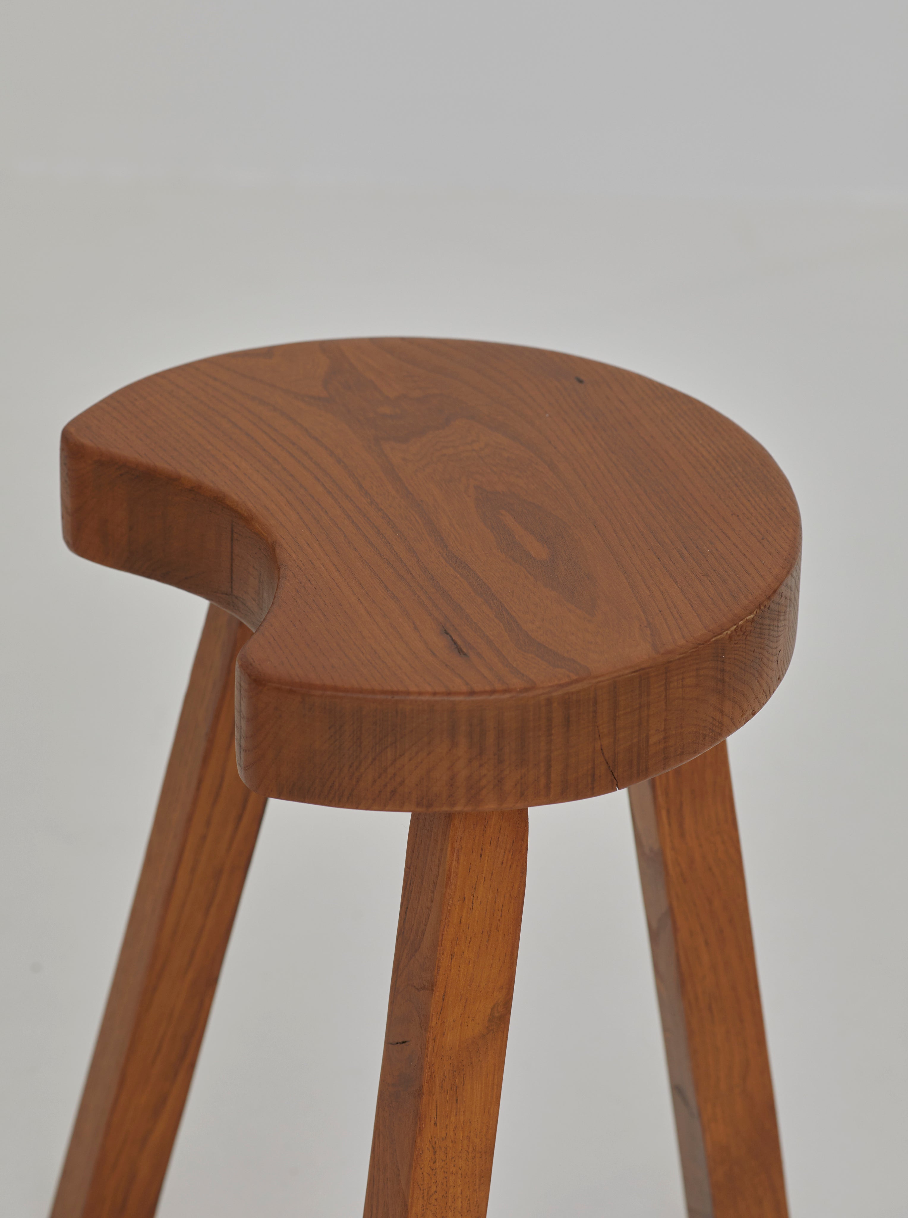 Vintage French handcrafted tripod stool in brutalist style, solid beech wood C. 1960 — back view showing curved wooden seat a
