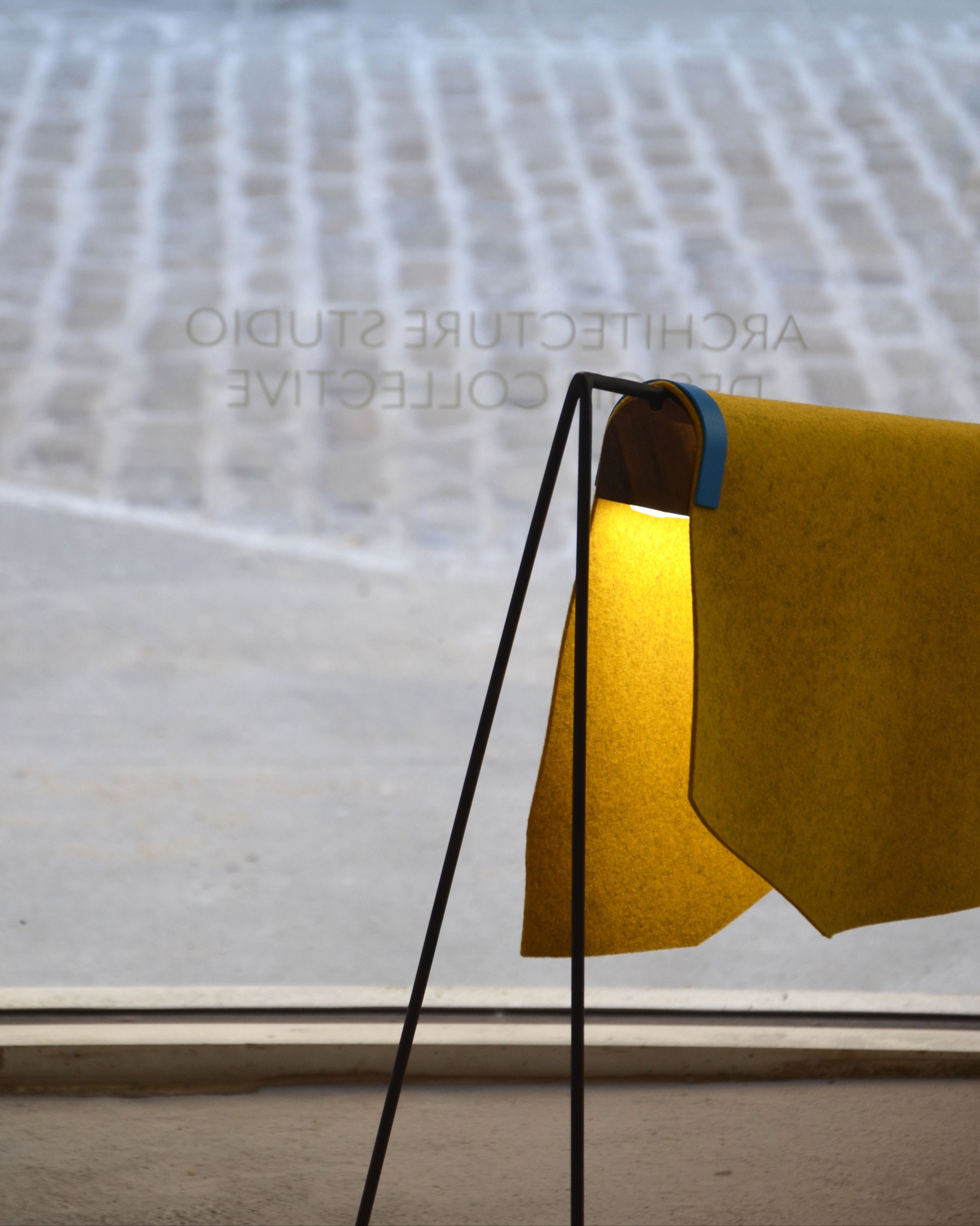 Lomo Lamp' by Natural Urbano — close-up of yellow felt shade and metal frame
