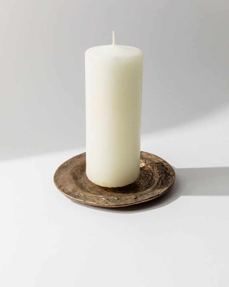 1960s Bronze Candleholder — close-up of textured bronze base with white candle