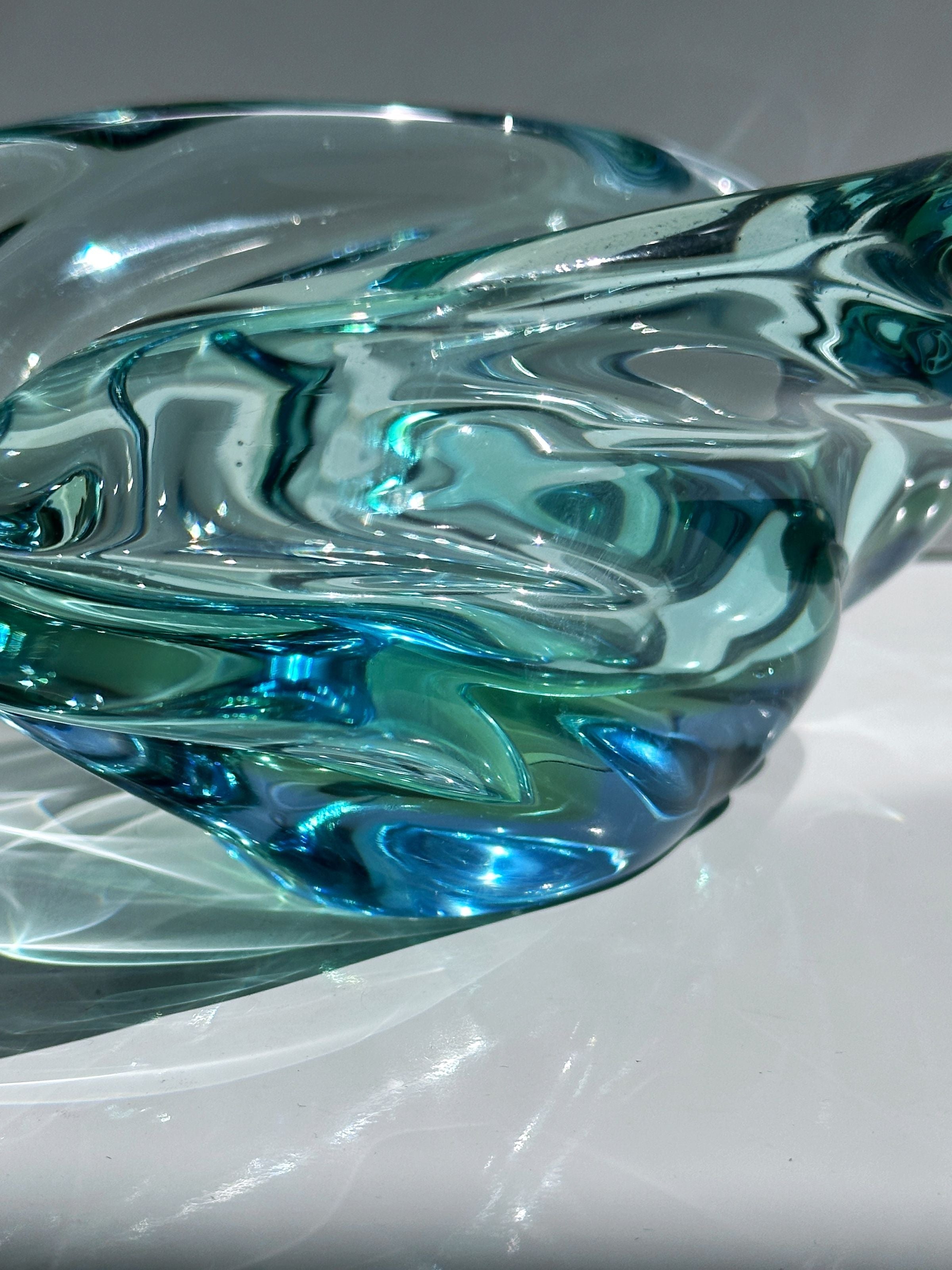 Aqua blue glass vide-poche detail showing swirled organic pattern