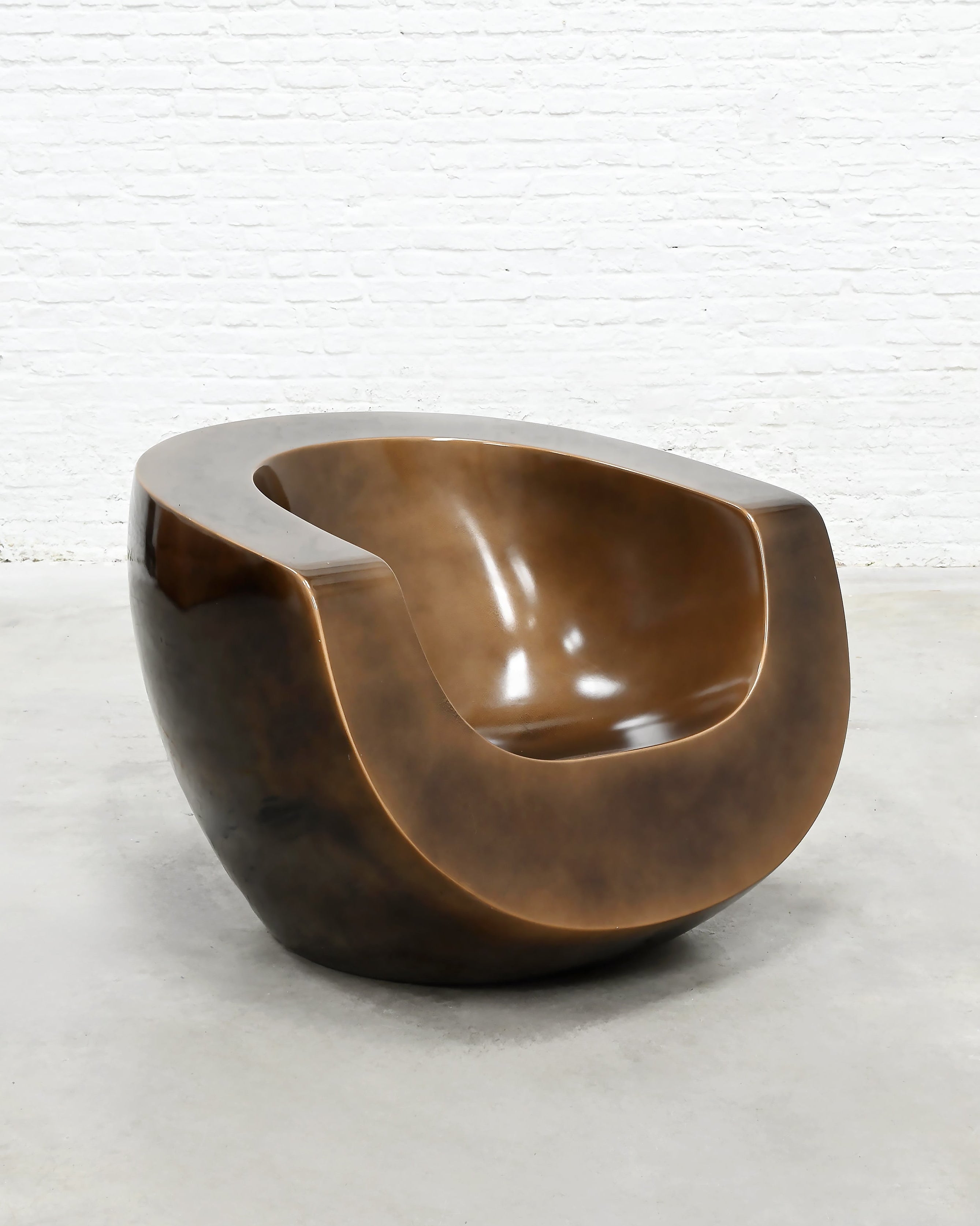 Brown fiberglass Moon Chair sculptural form side profile view