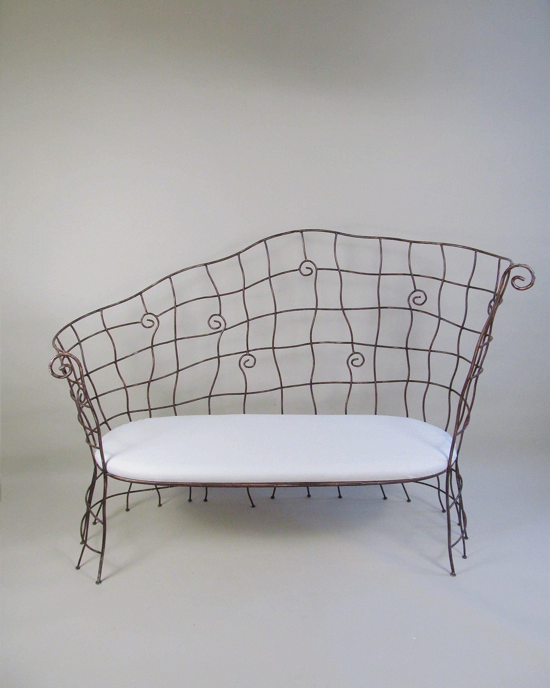 Scrollwork Iron Bench by Myakin | The Oblist — handcrafted iron, white cushion