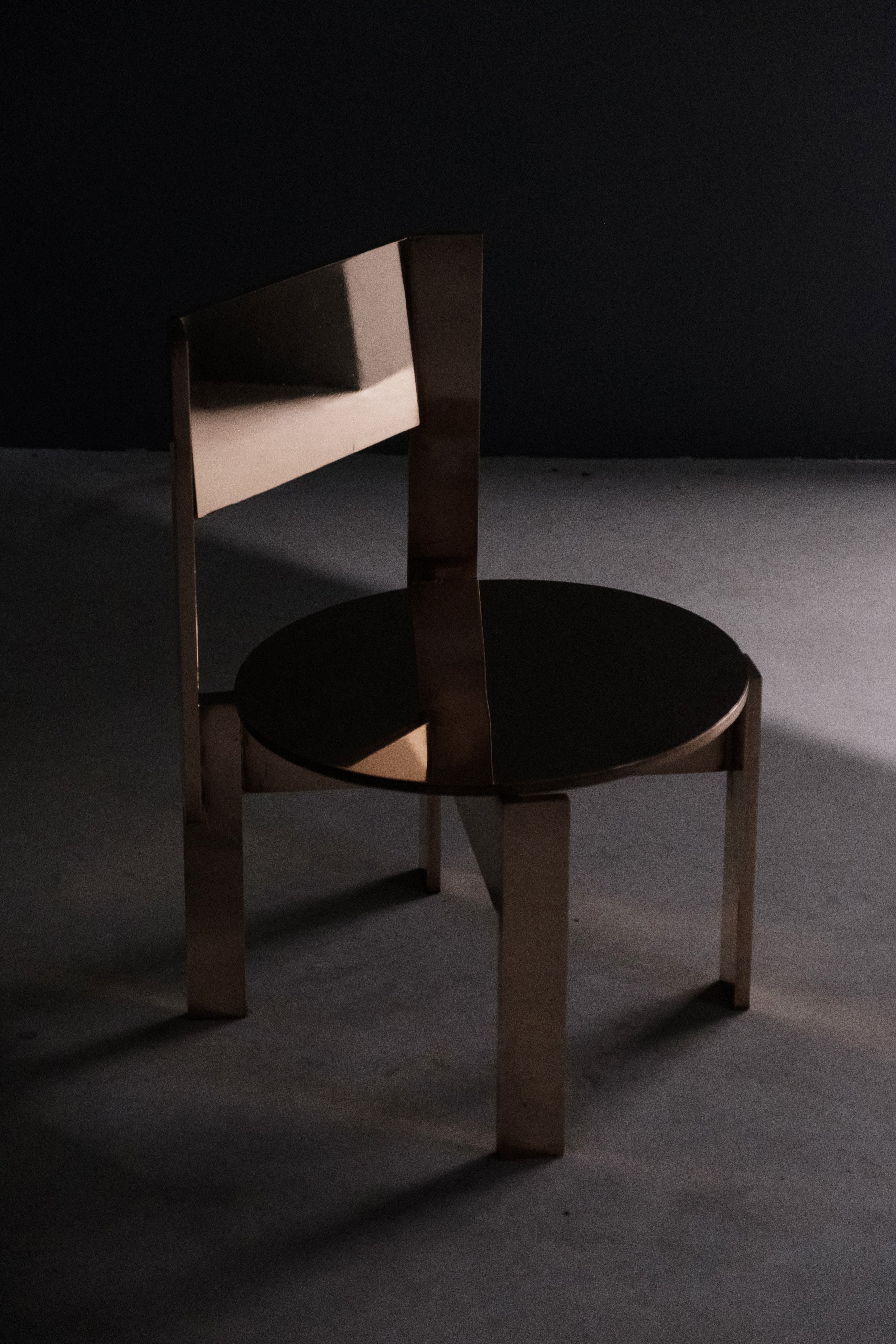 Ch 19.1 [b] - Low Chair — close-up of polished brass seat and back