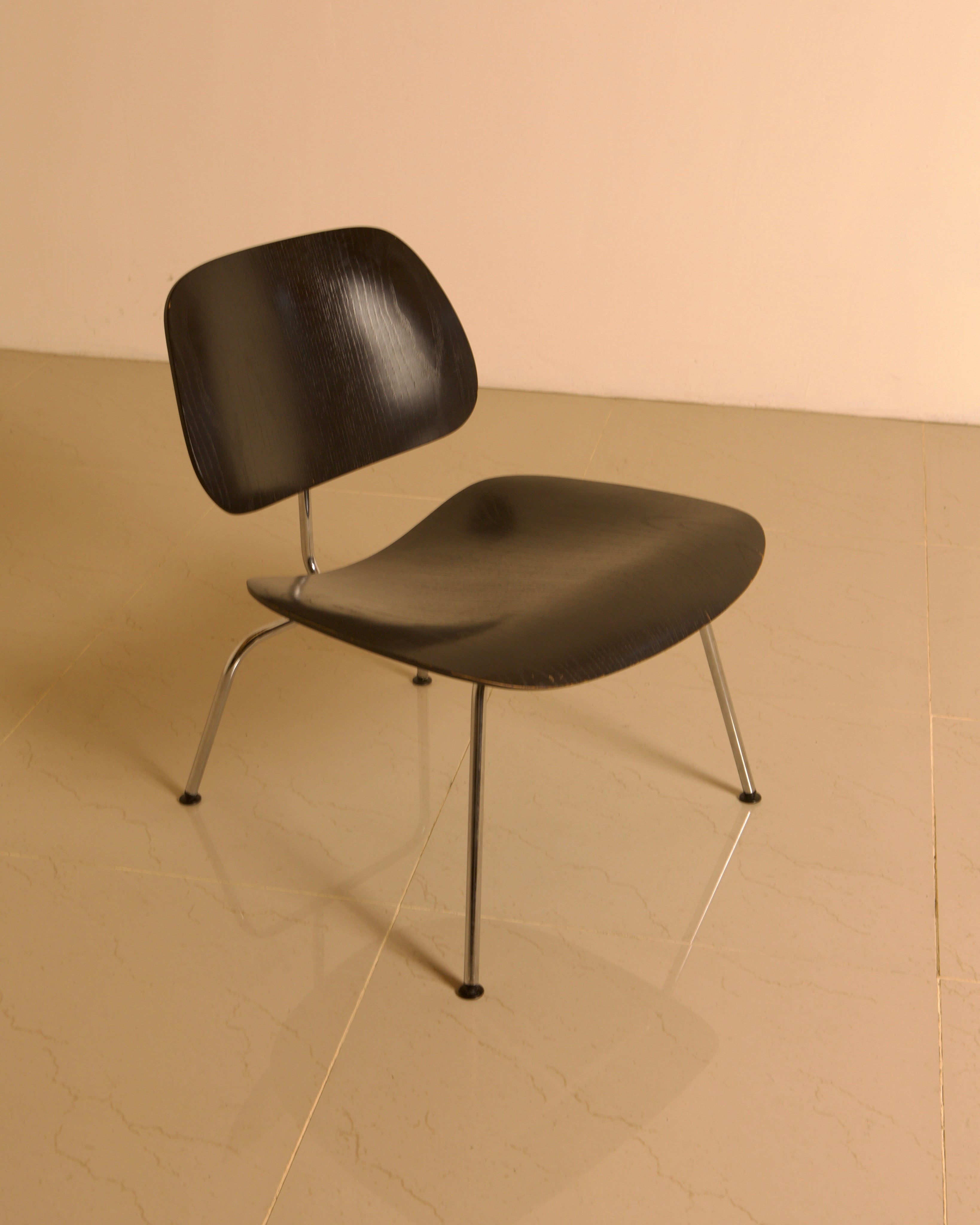 LCM Chairs by Charles and Ray Eames for Herman Miller, 1960s — angled view on polished floor