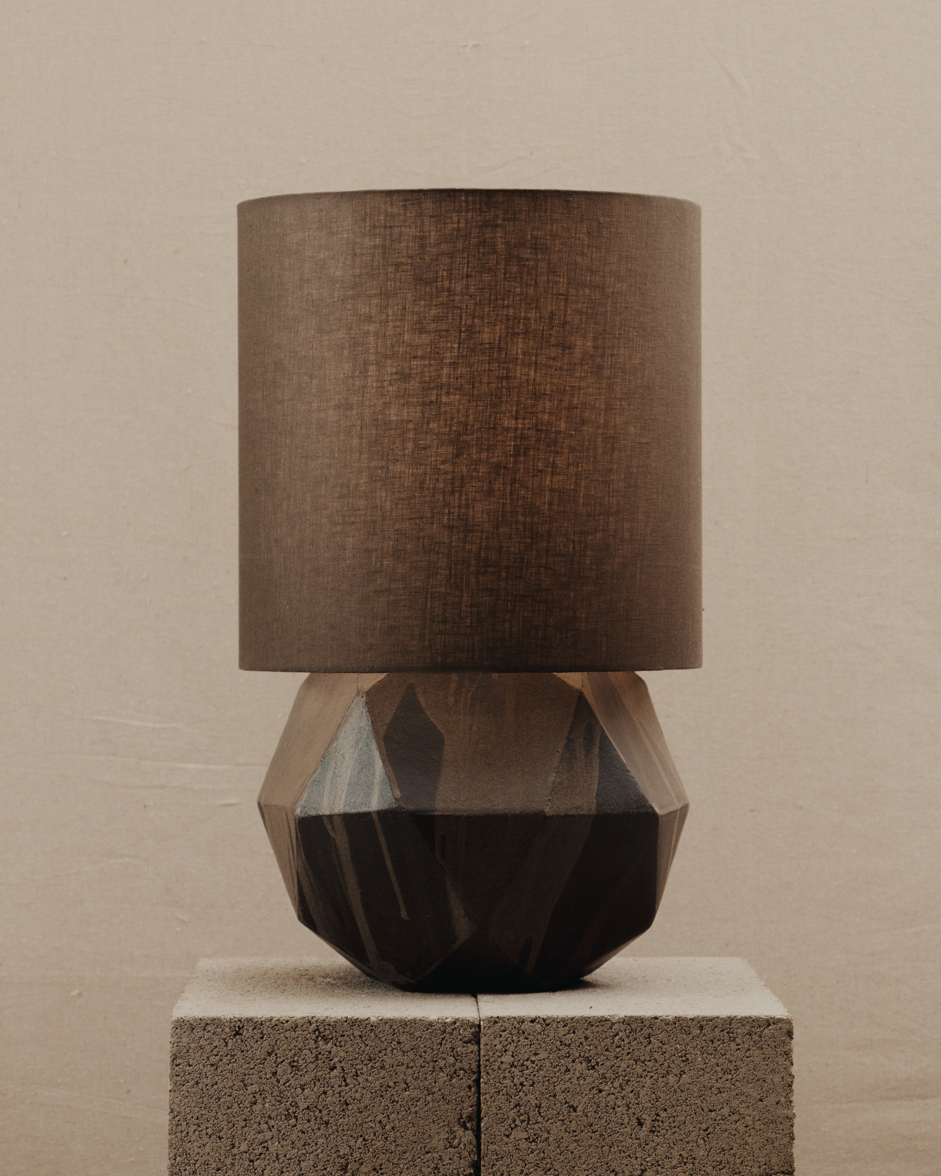 Geode Lamp — front view on textured stone pedestal