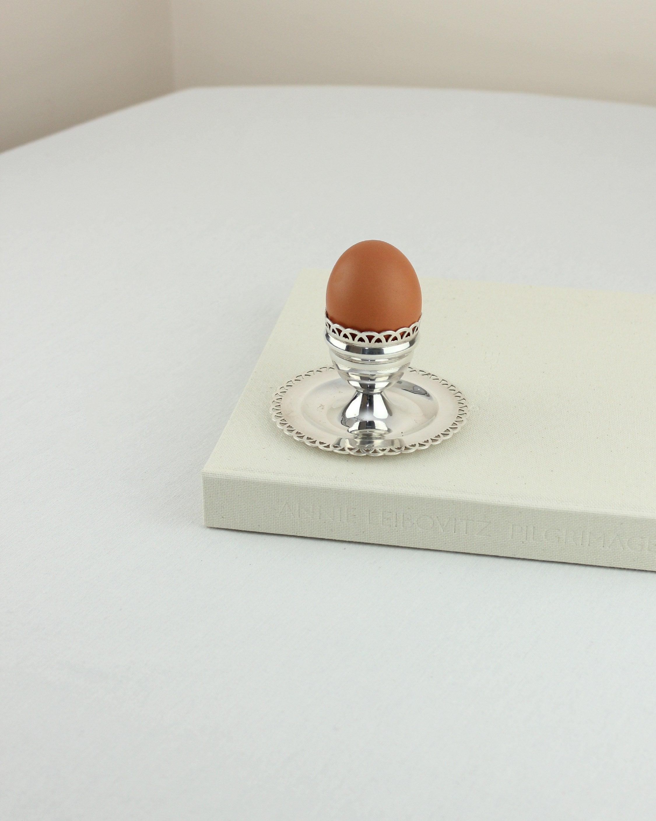 Alpaca Egg Cup — side angle on light gray surface