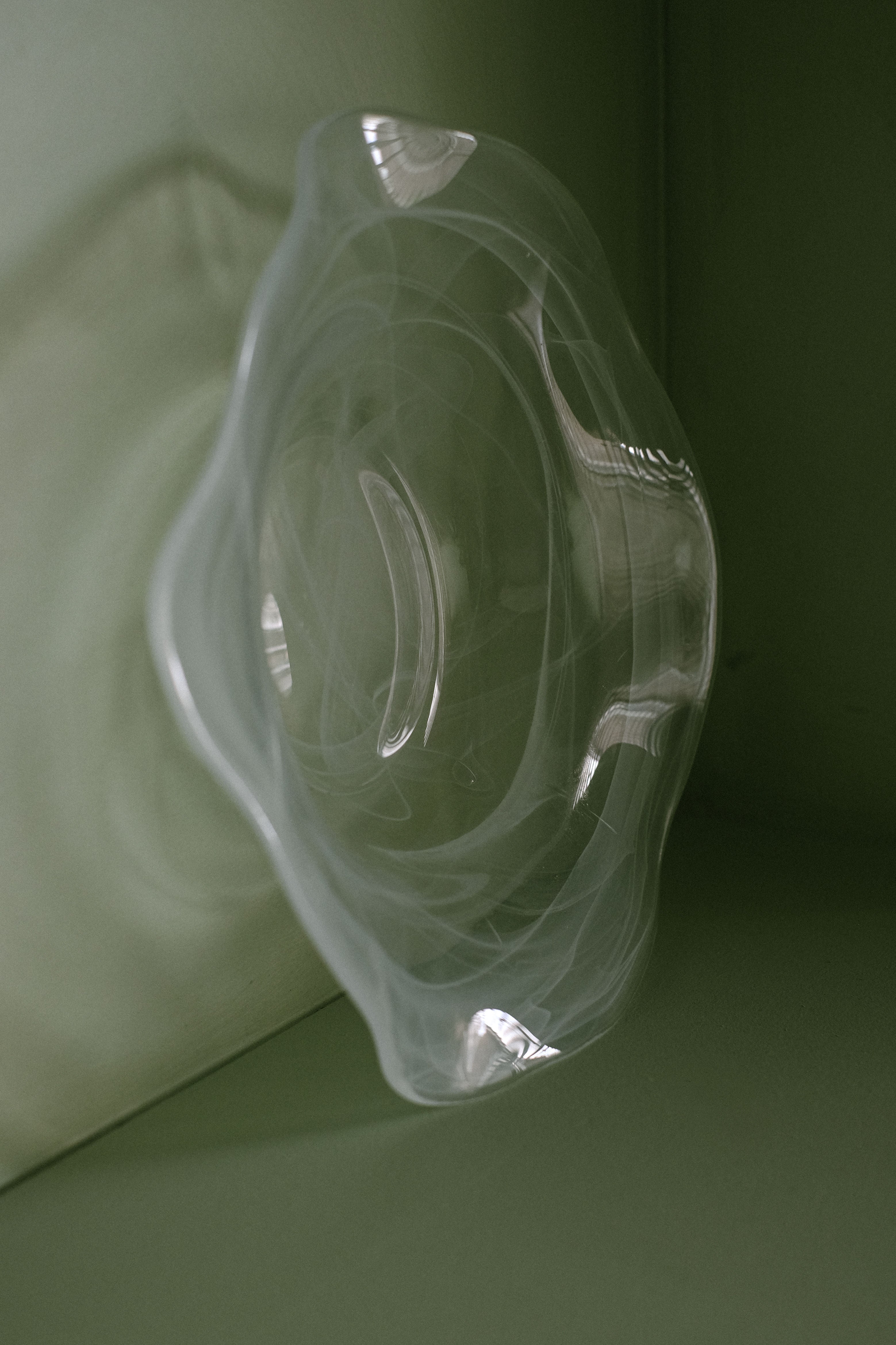 Swirl Glass Bowl — back view on green background