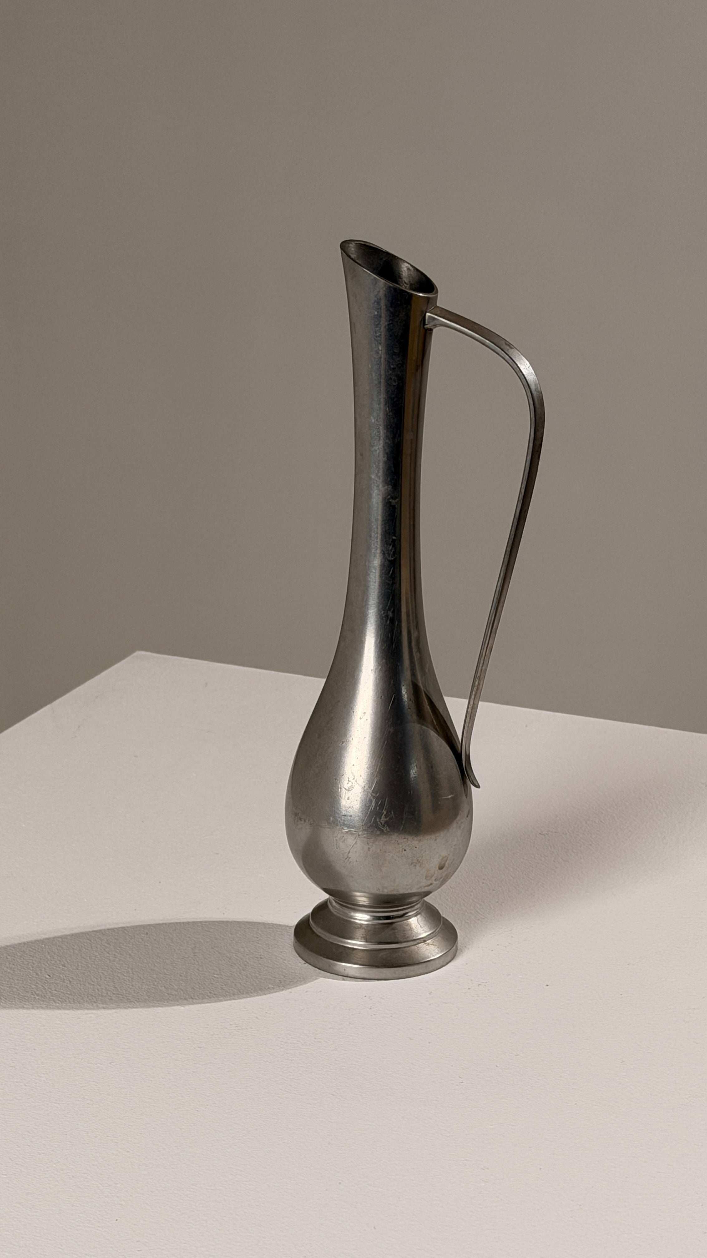 Pewter Pitcher, Paris, France, circa 1930 — angled view highlighting shiny metal finish