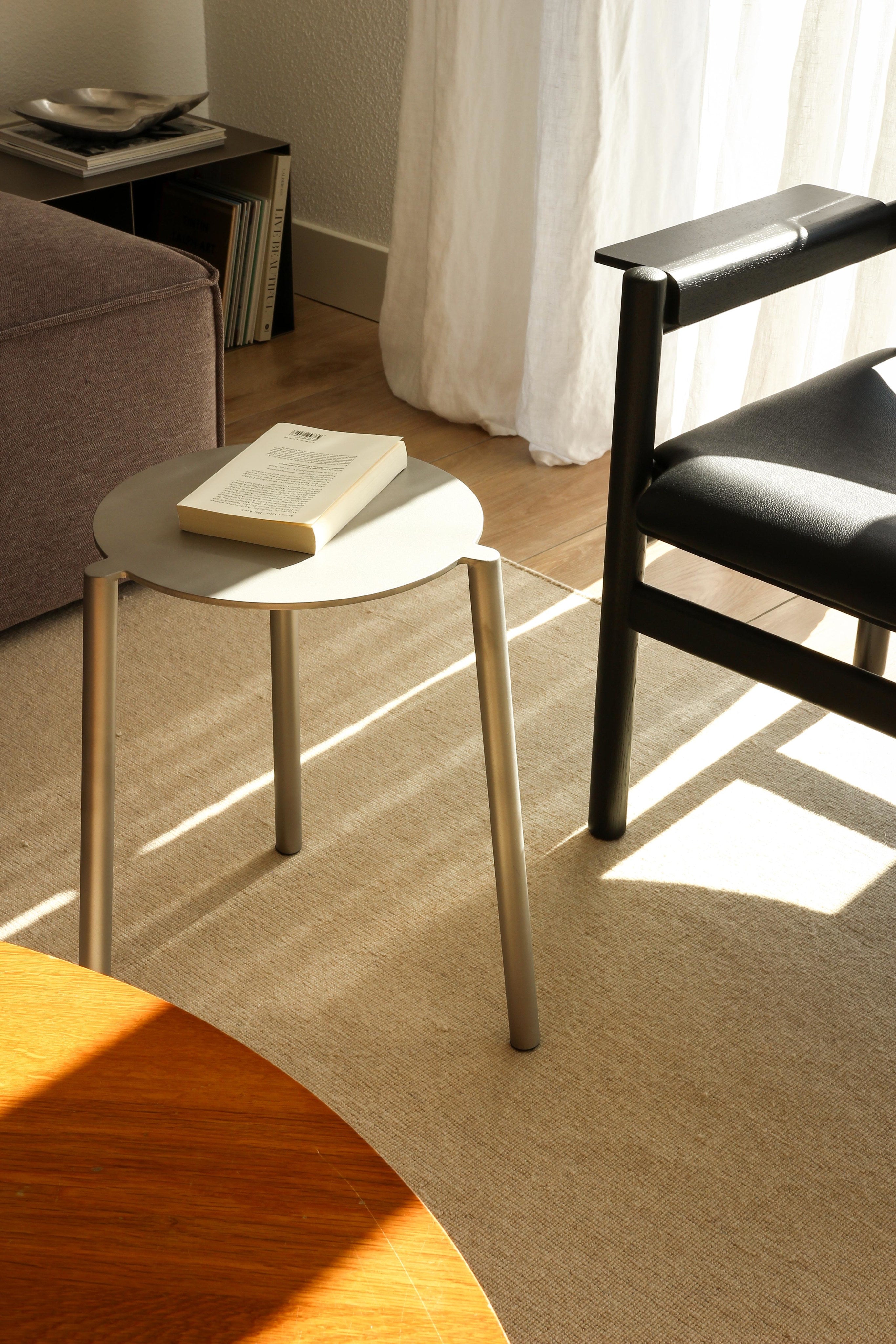 Stool - Isla x Paul Delrez - Stainless Steel — angled view in modern living room