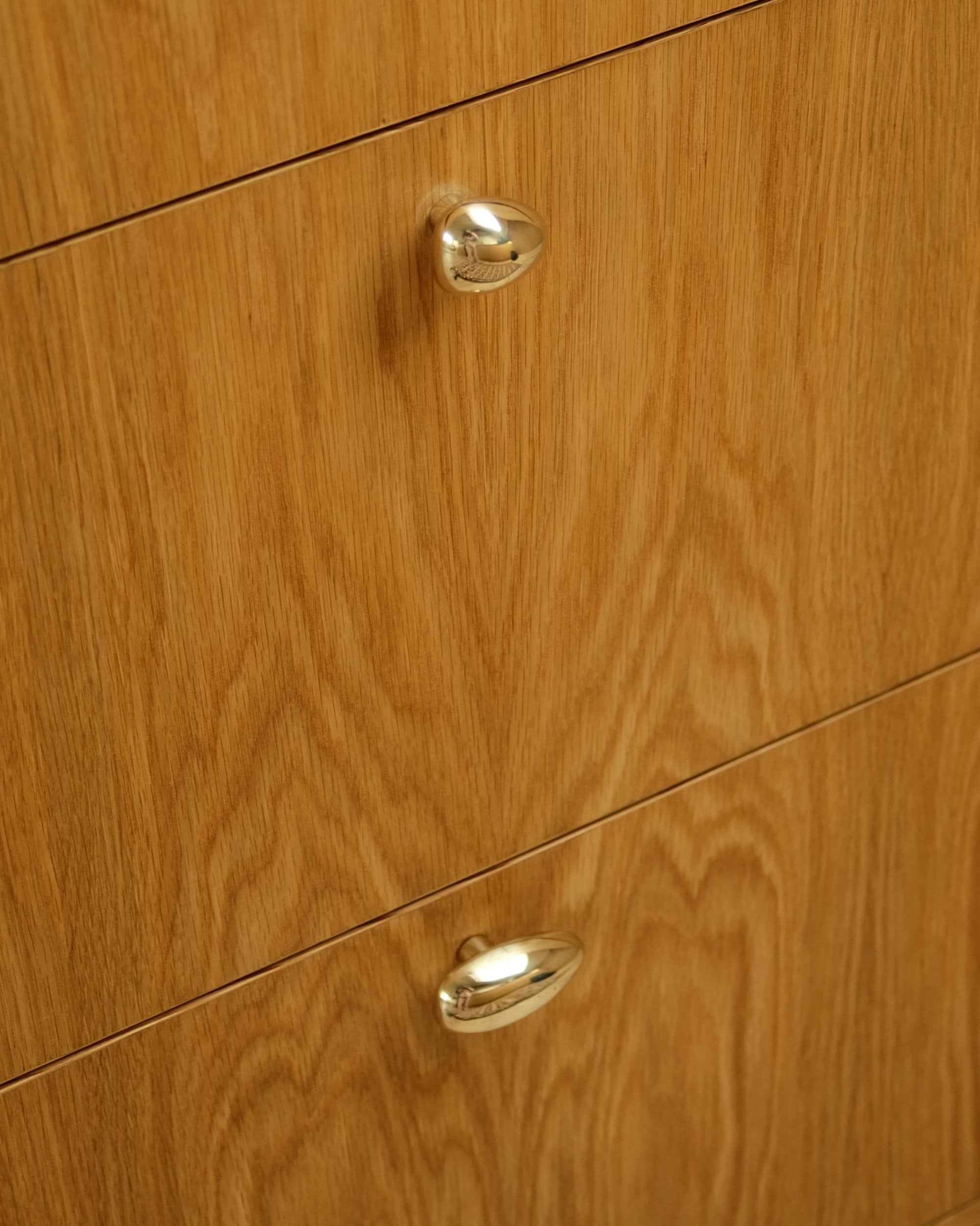 MOMI Cabinet Knob/Wall Hook Short Mini — close-up of polished metal on wooden cabinet