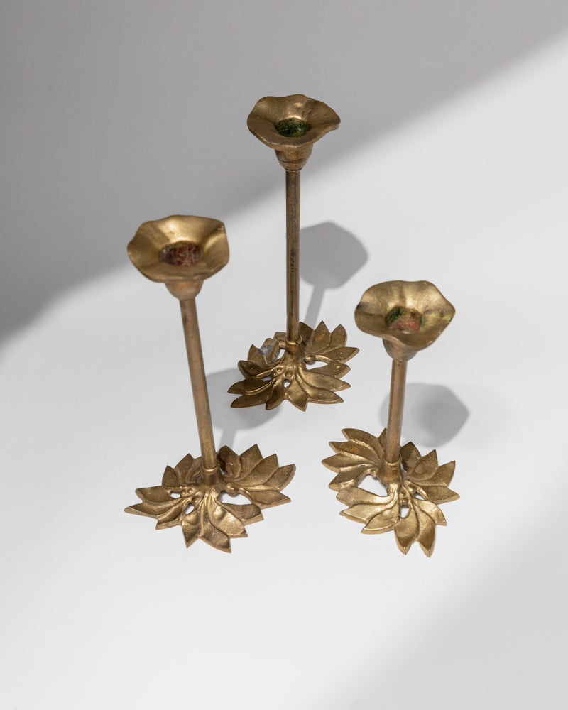 Detail view of Italian brass candle holders with lotus flower bases