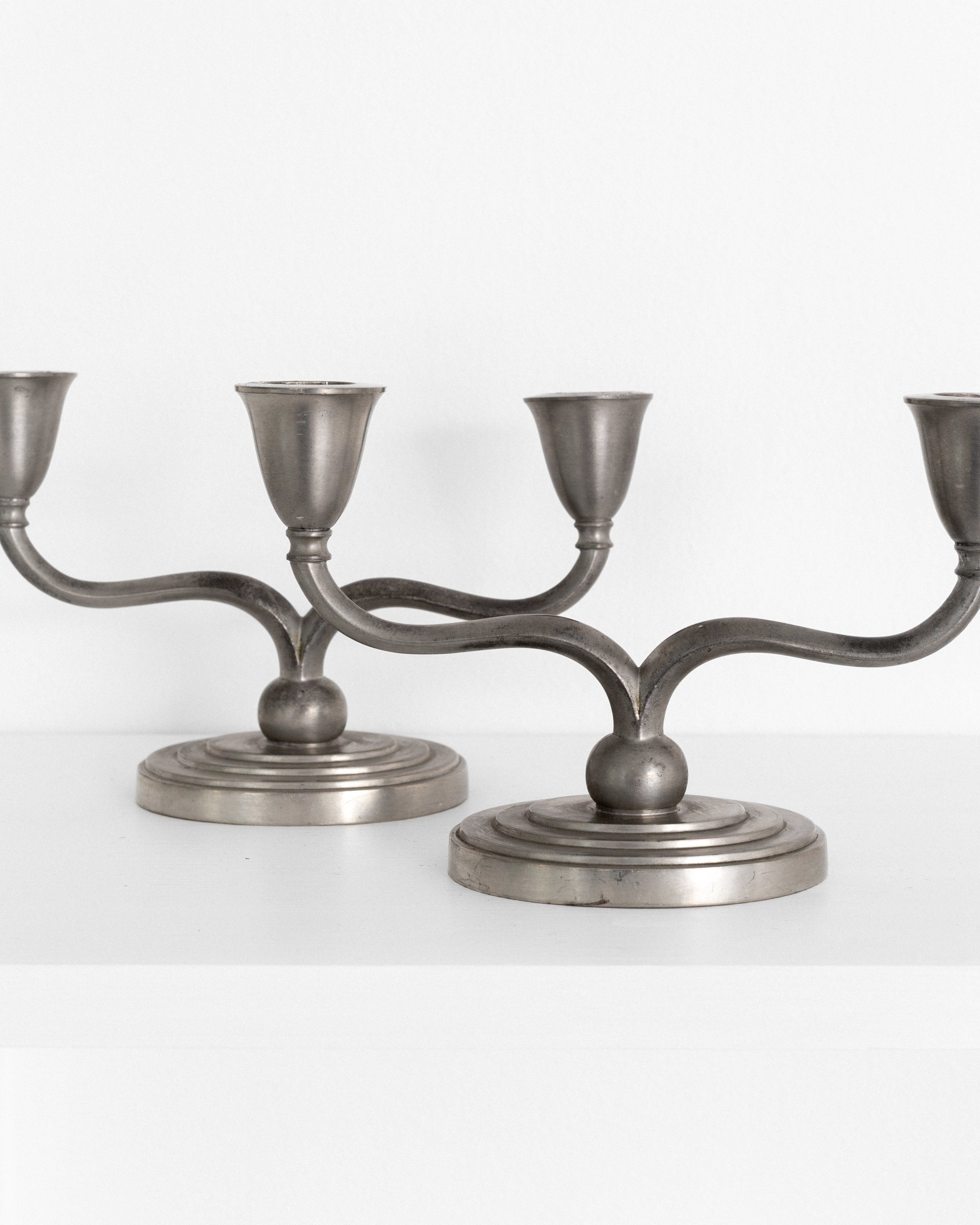 Pair of Pewter Candelabras by Just Andersen, Denmark, 1930s-40s — side angle on white shelf