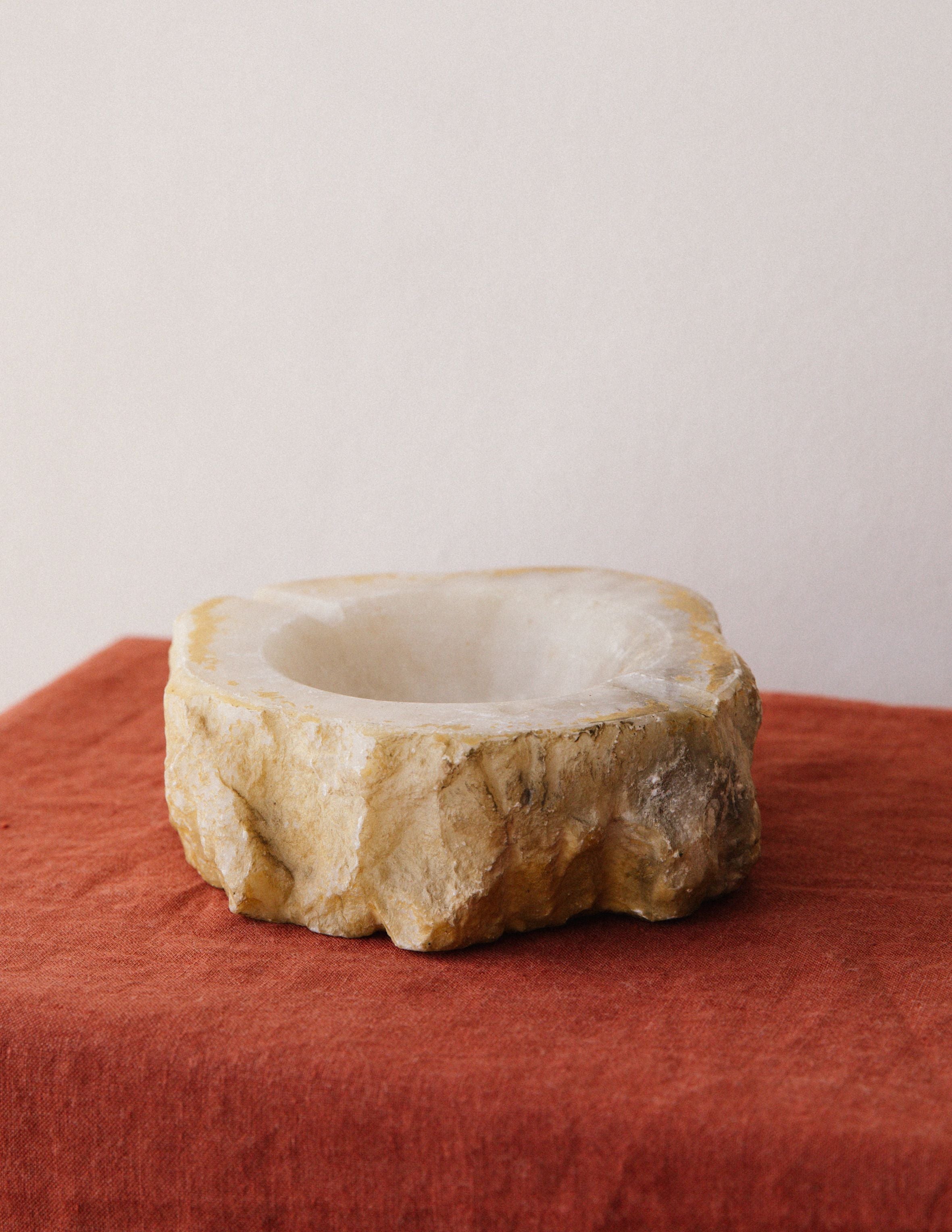 Raw alabaster ashtray with natural stone texture and carved bowl
