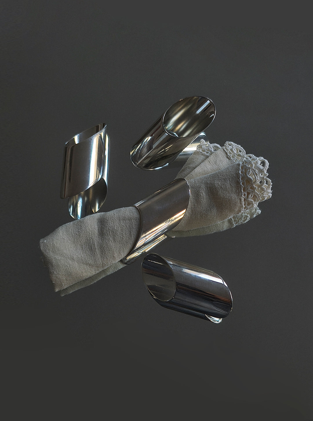 Set of 4 Silver-plated Napkin Rings — side angle with linen napkin wrapped
