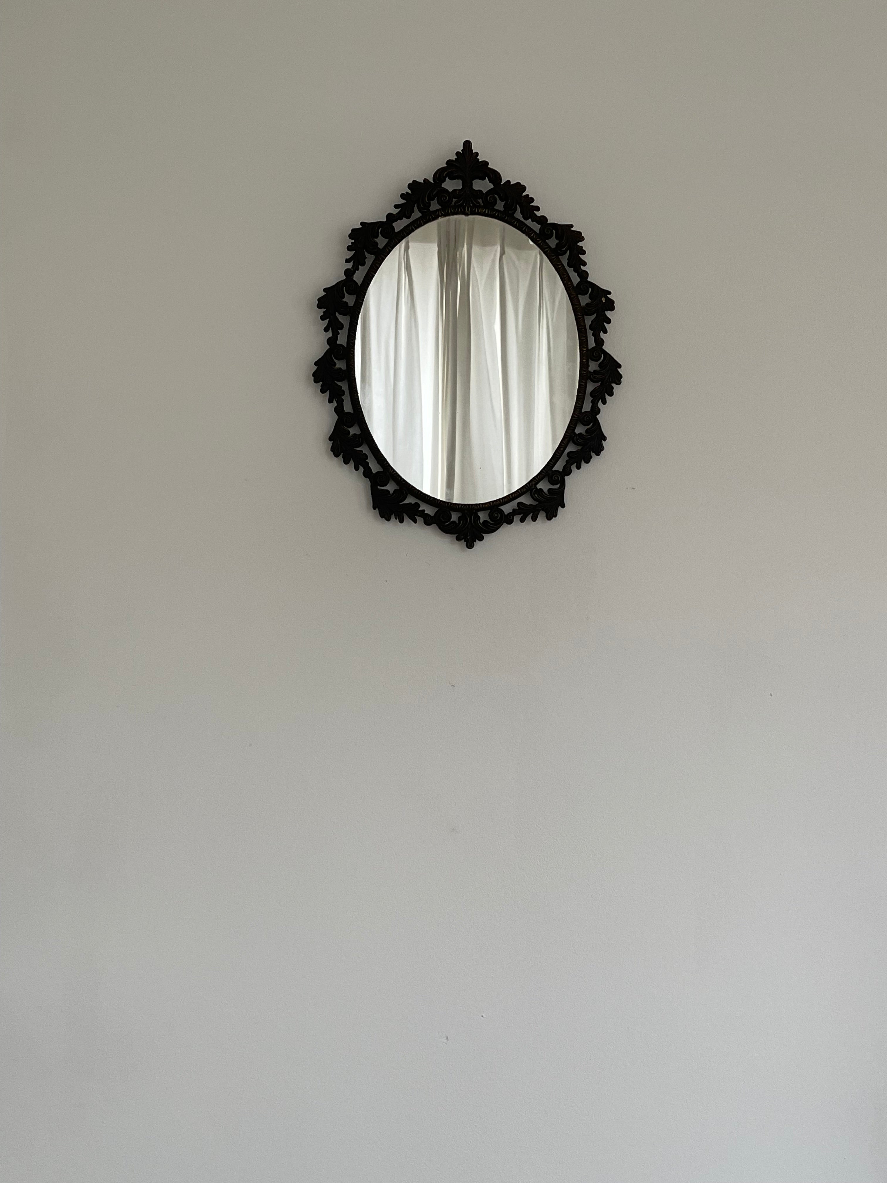 Ornate Vintage Oval Mirror, Rococo Frame — hung on light wall with curtains