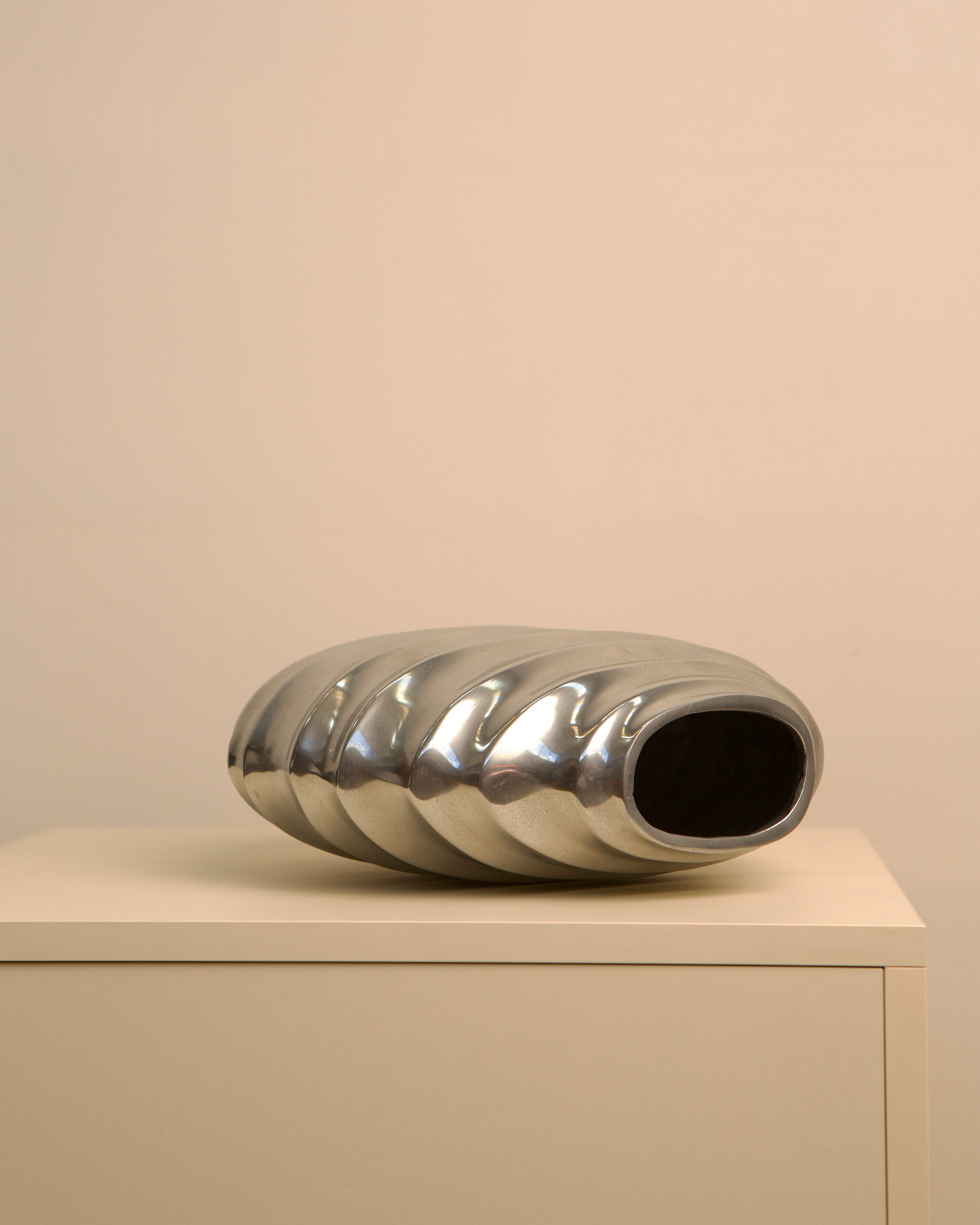 Sculptural ridged aluminum vase with spiral texture detail