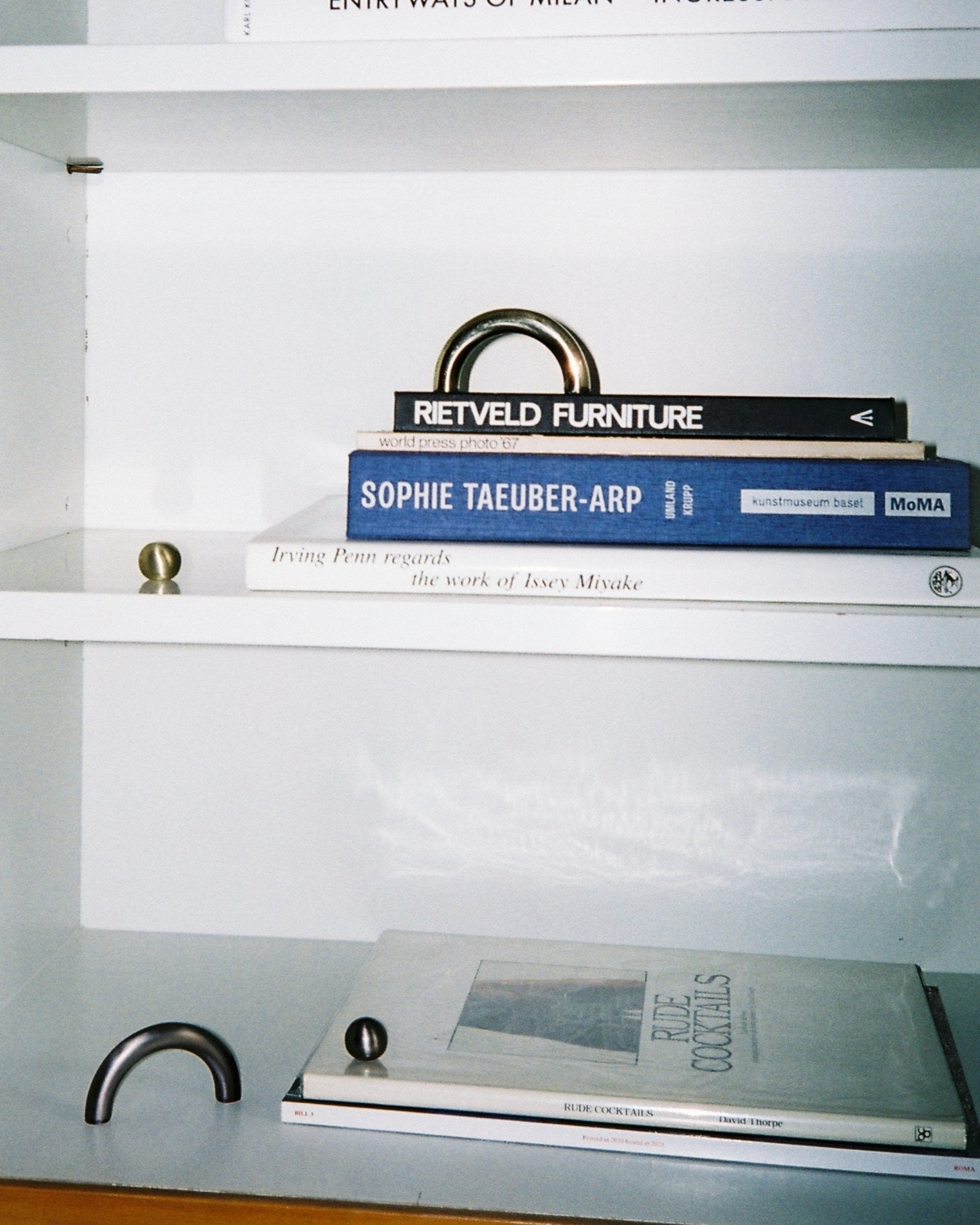 CERCLE Cabinet Pull Thin (2 sizes) — displayed on white shelf with books