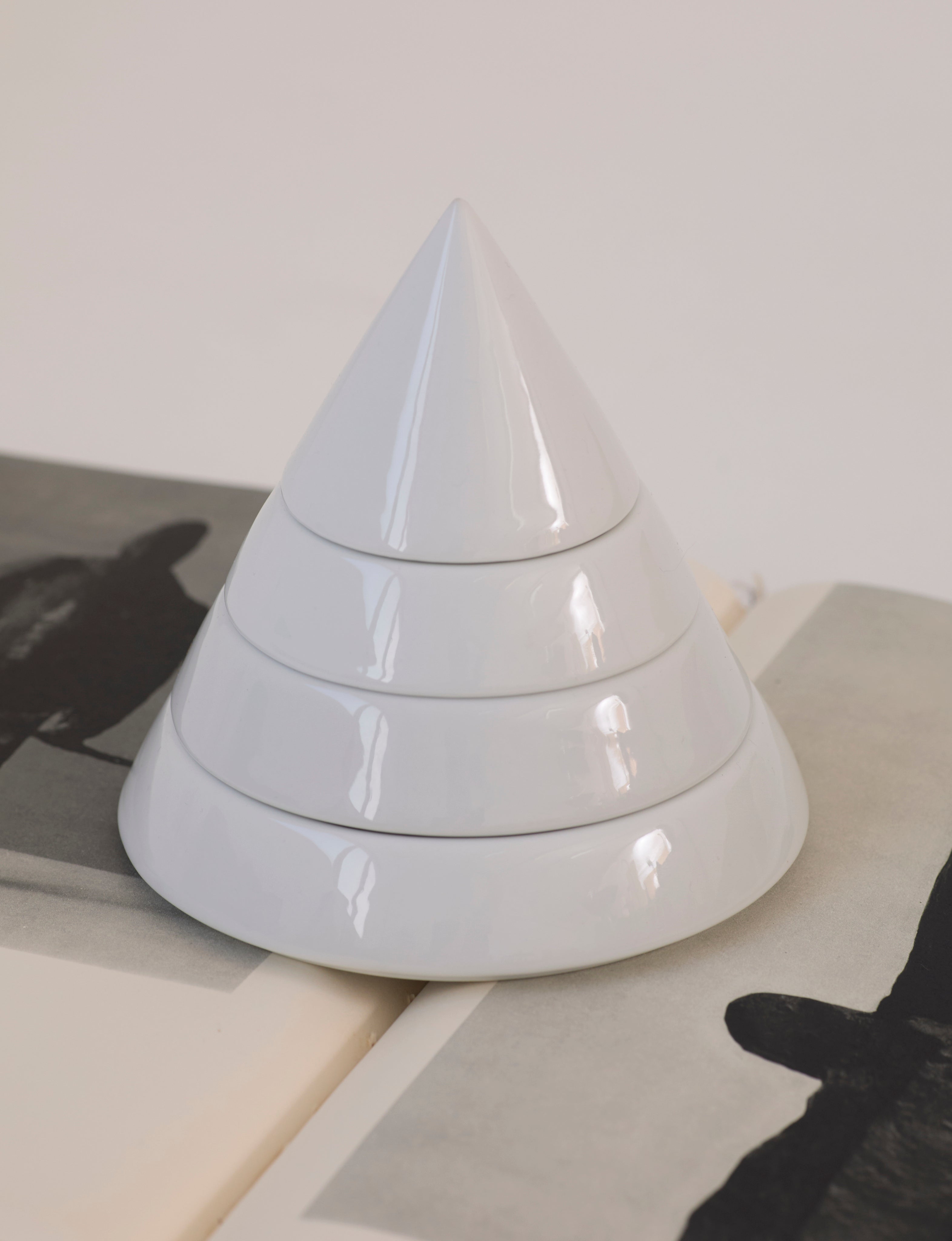 Pyramid Multi-Layer Organizer Box / Ashtray in Ceramic — angled view on stacked books