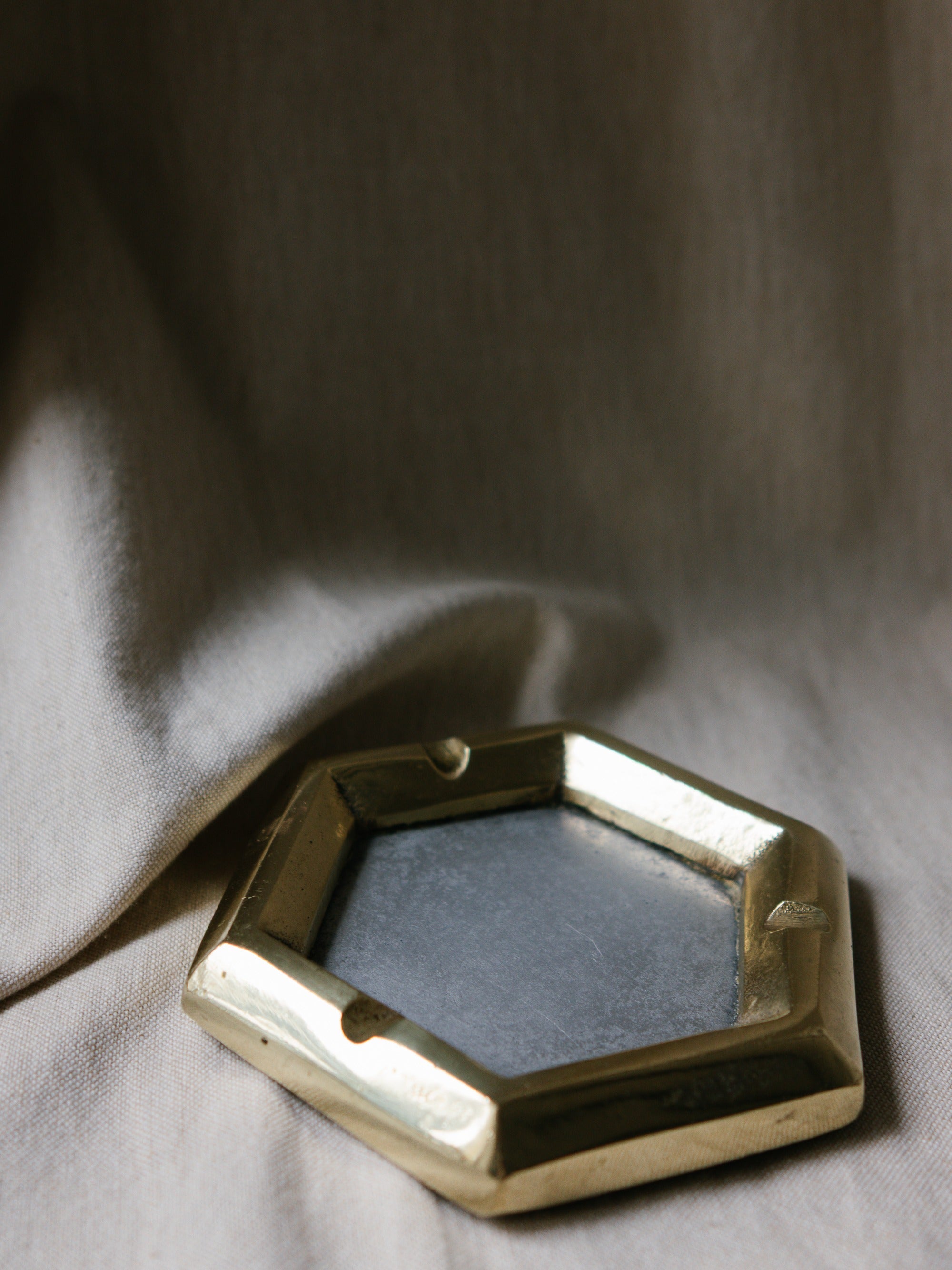 David Marshall Hexagonal Ashtray, Spain, c. 1970s — angled view on textured fabric