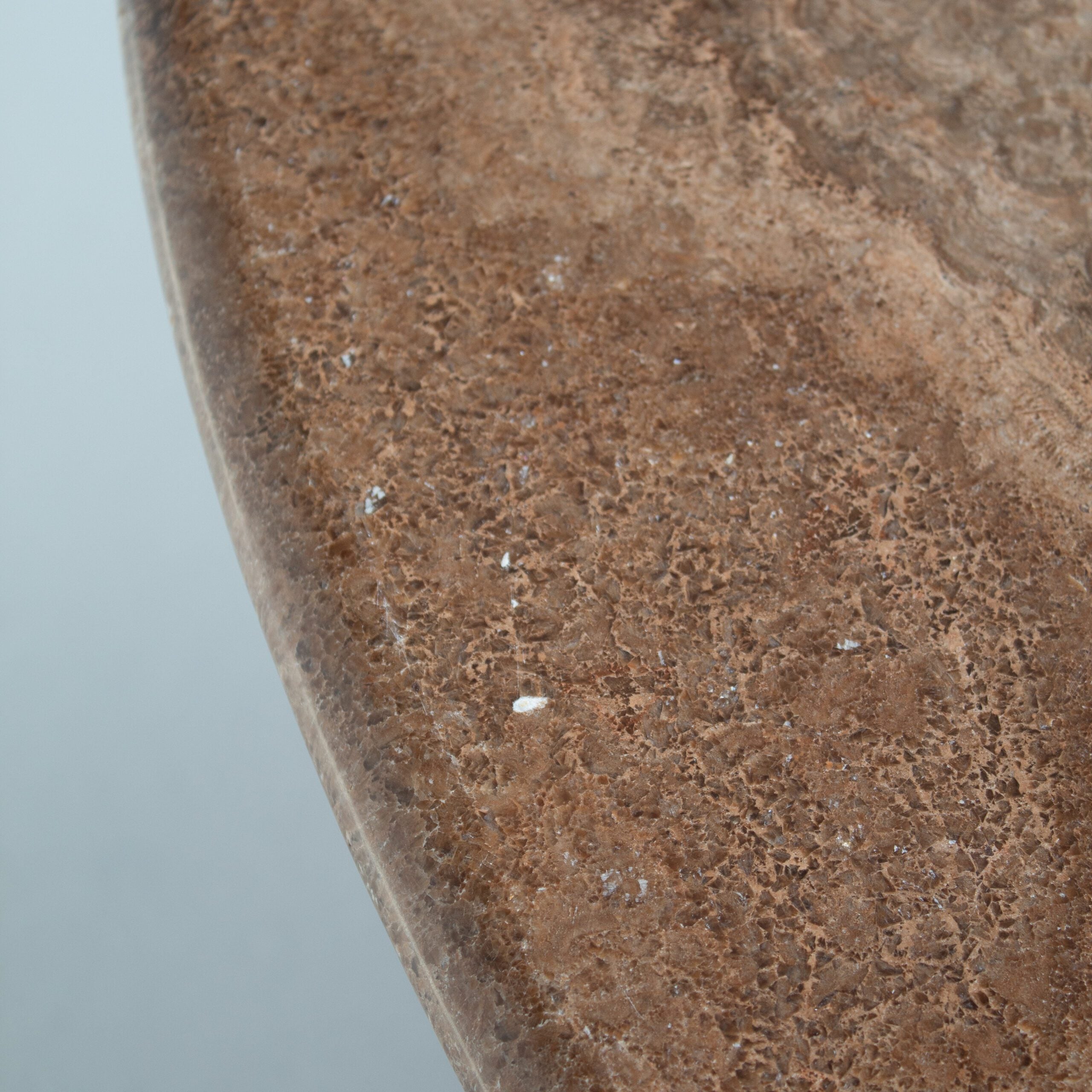 Round Marble Dining Table with Burgundy Lacquered Base — close-up of marble surface texture