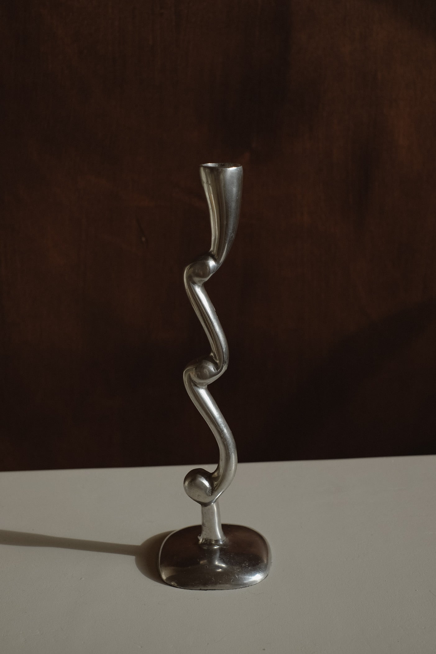 Curly Candle Holder — side angle of polished metal design
