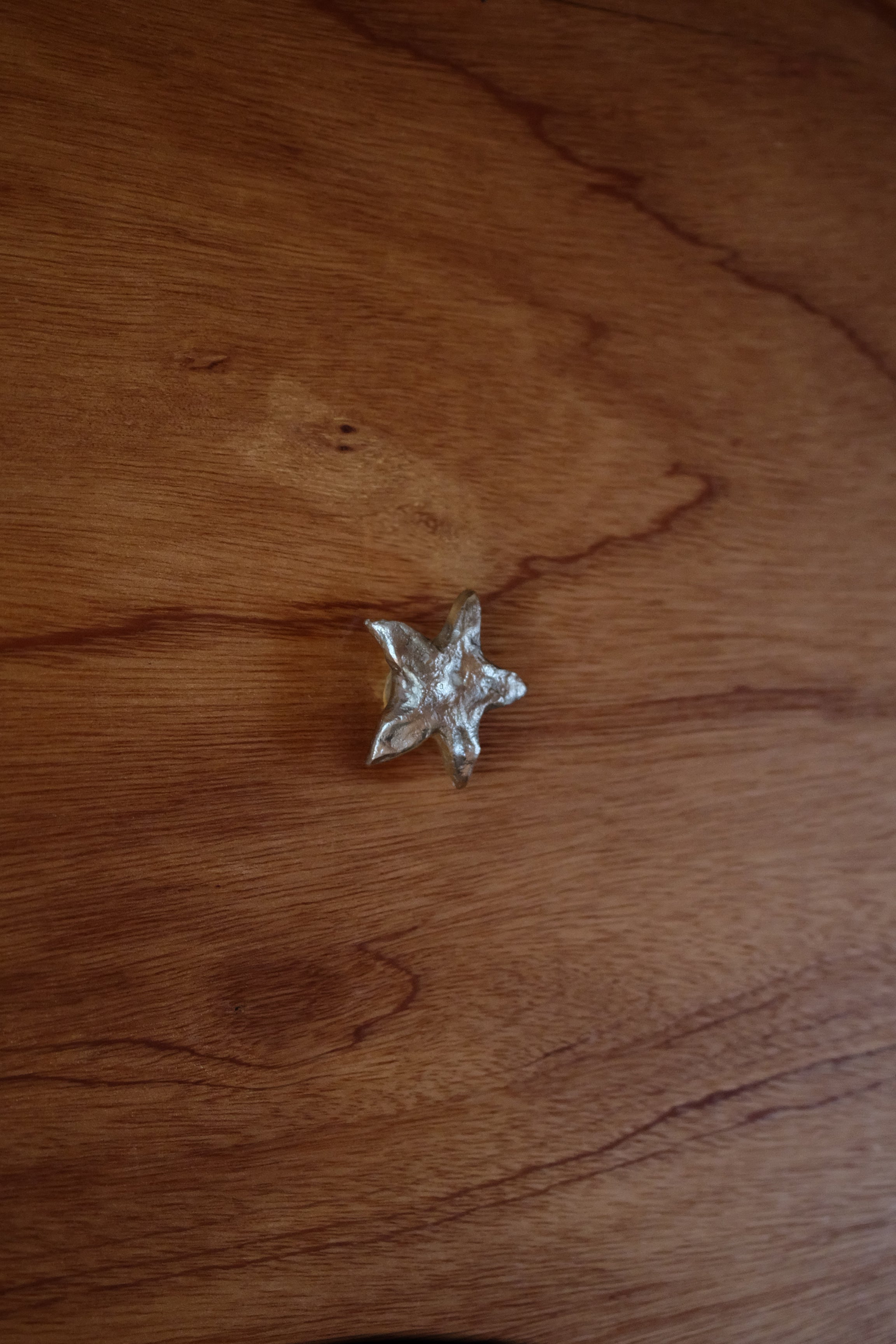STAR Cabinet Knob/Wall Hook — top view on wooden surface