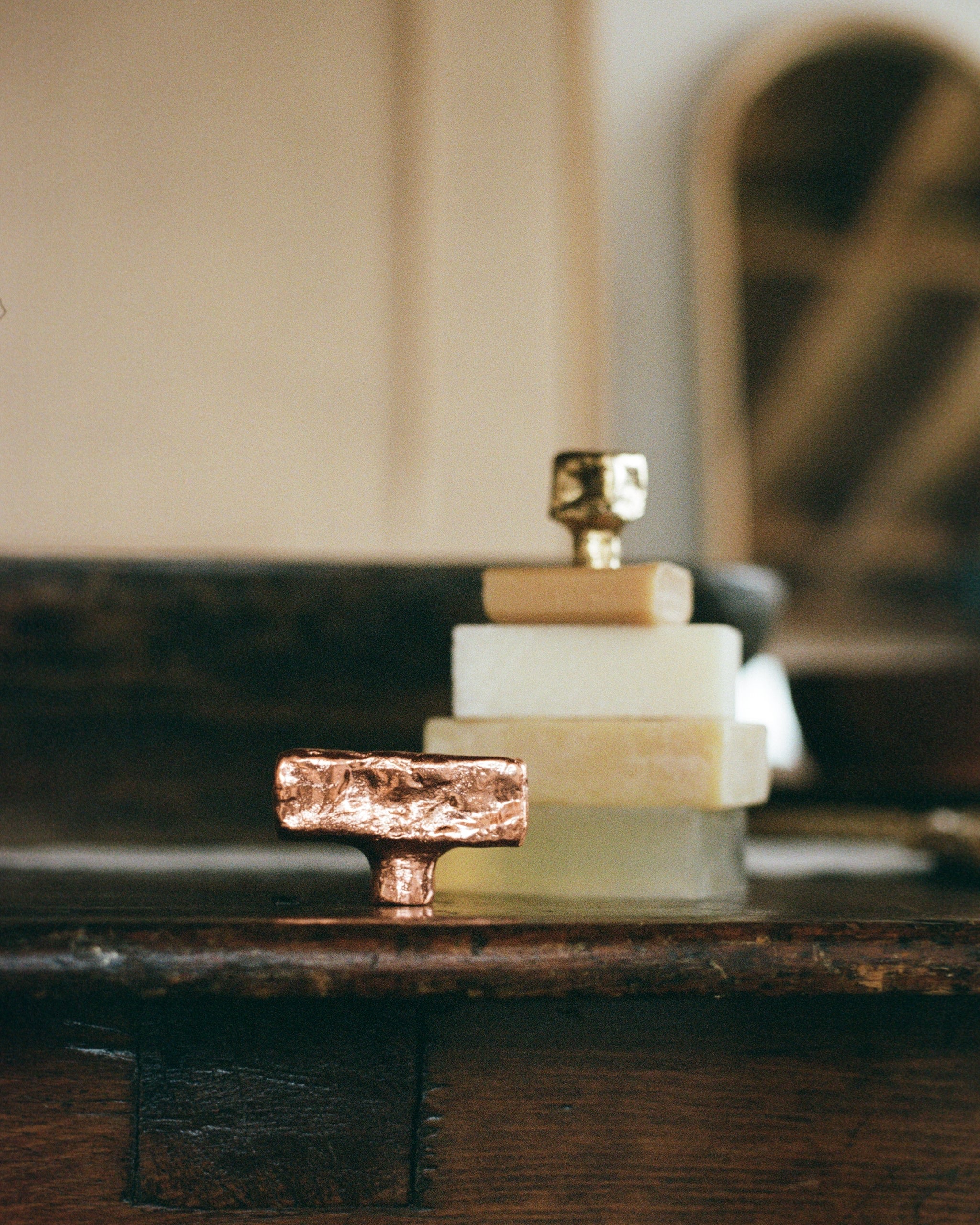 ISLE Cabinet Knob/Wall Hook Medium — close-up of textured copper finish on wooden surface
