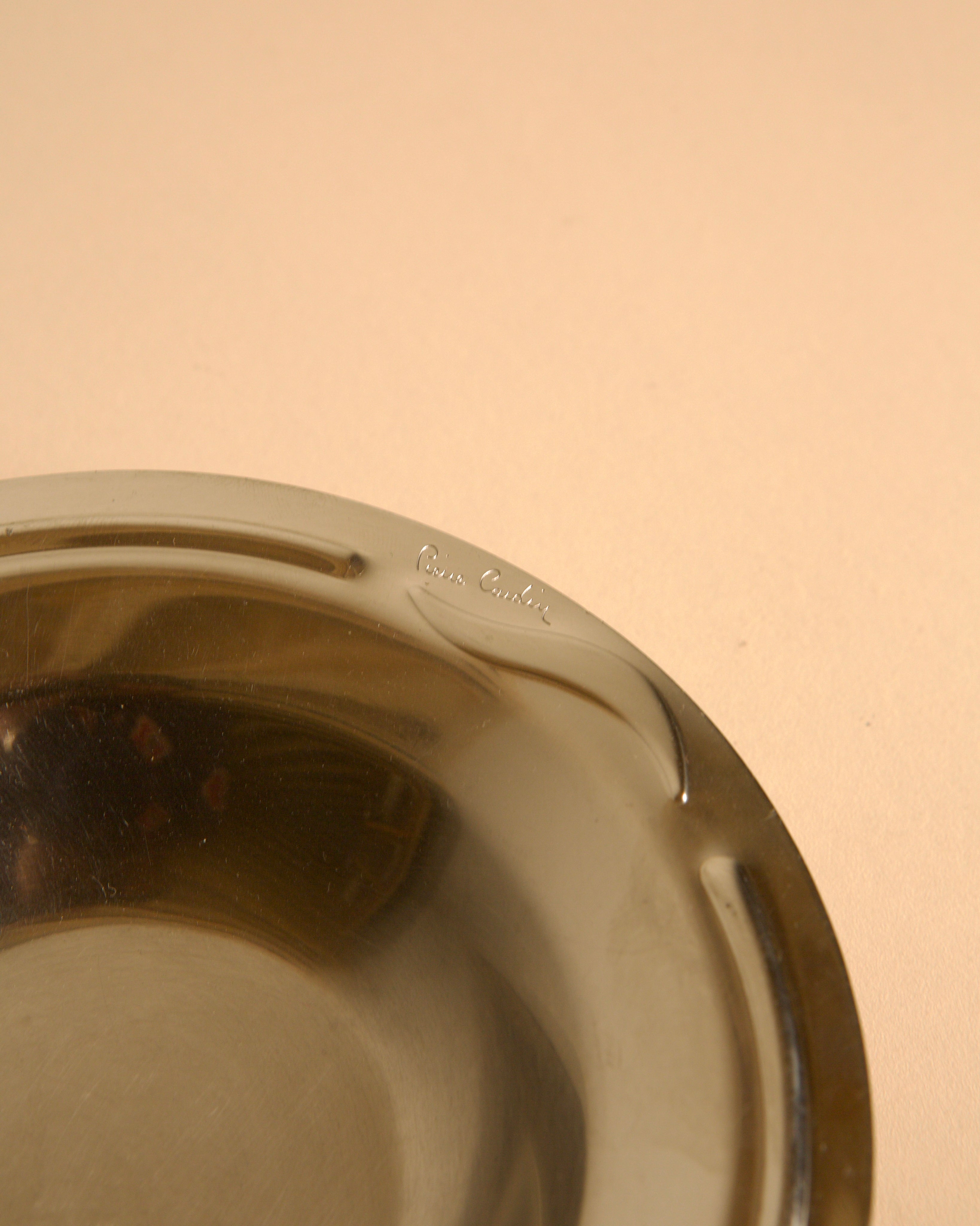 Circular stainless steel valet tray by Pierre Cardin, 1980s — close-up of polished surface
